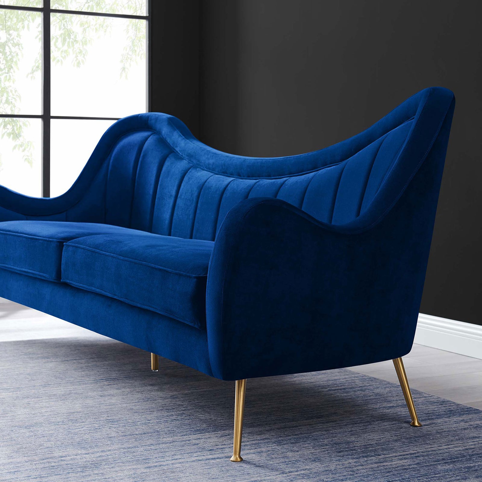 Navy velvet Cheshire sofa styled in a modern room, highlighting the curved back and gold legs || EEI-5874-NAV || detail_room