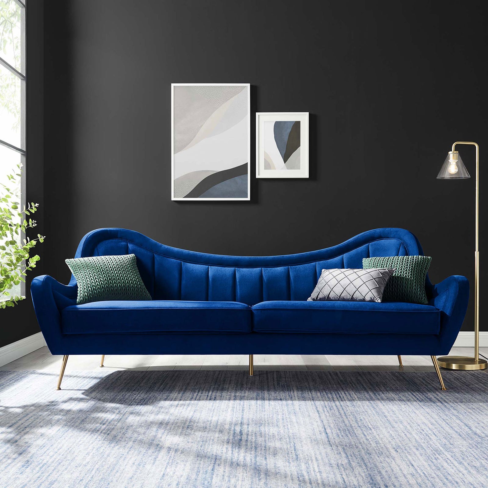 Cheshire navy velvet sofa with accent pillows and gold legs anchoring a contemporary living room || EEI-5874-NAV || front_room