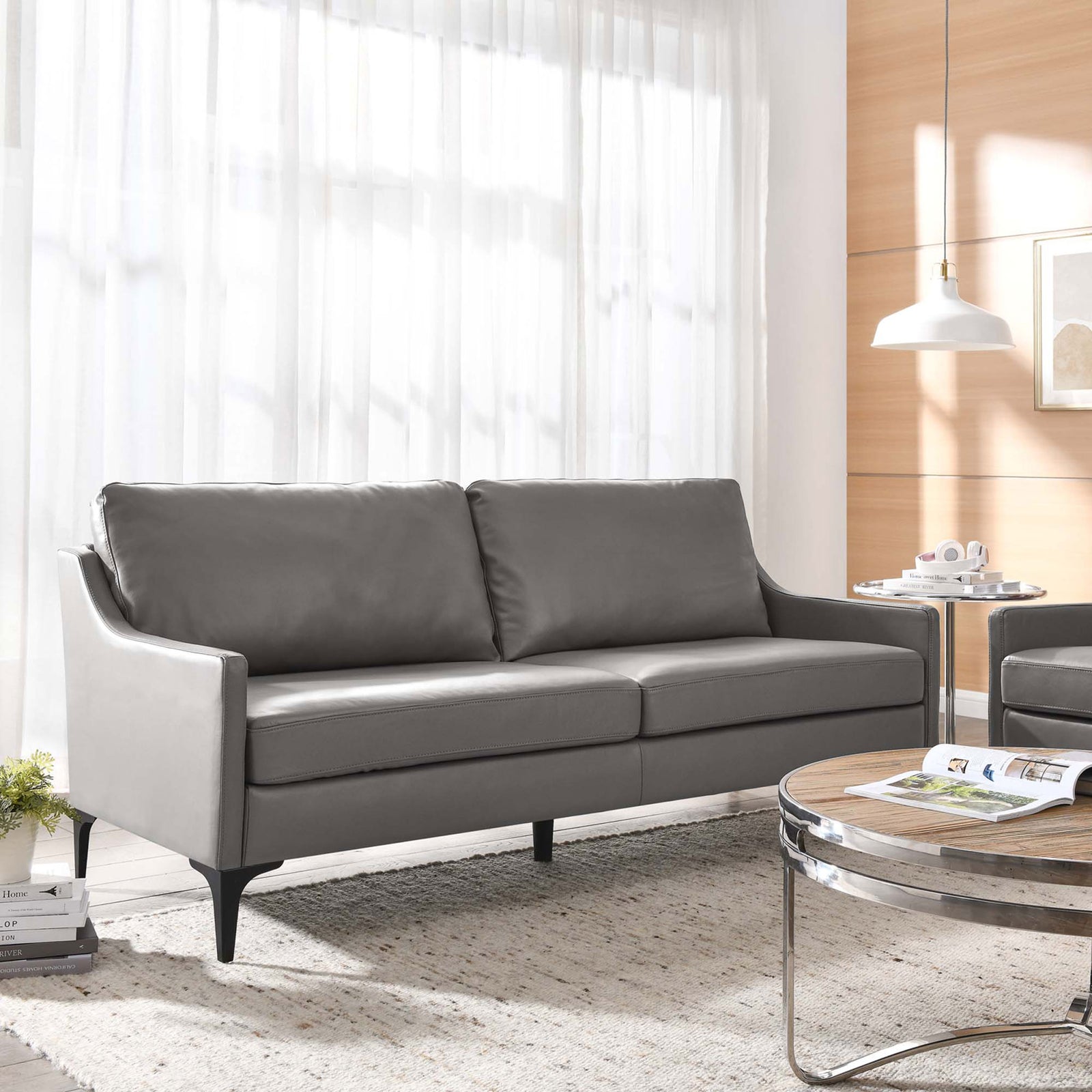 Gray leather sofa with plush cushions styled in a modern living room with light wood accents || EEI-6018-GRY || front_angle_room