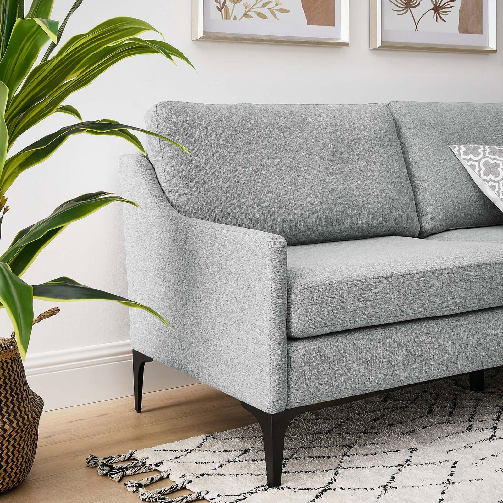 Light gray sofa styled in a modern living room with patterned rug, plant, and slim black legs || EEI-6019-LGR || detail_room