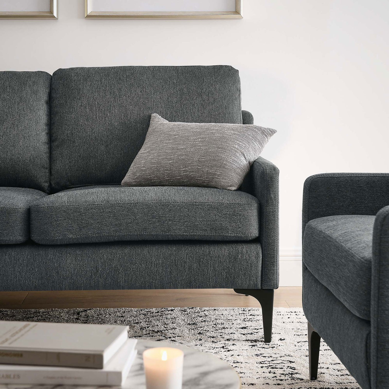 Corland loveseat styled with an accent pillow, showcasing cozy charcoal upholstery in an inviting lounge corner || EEI-6021-CHA || detail_room