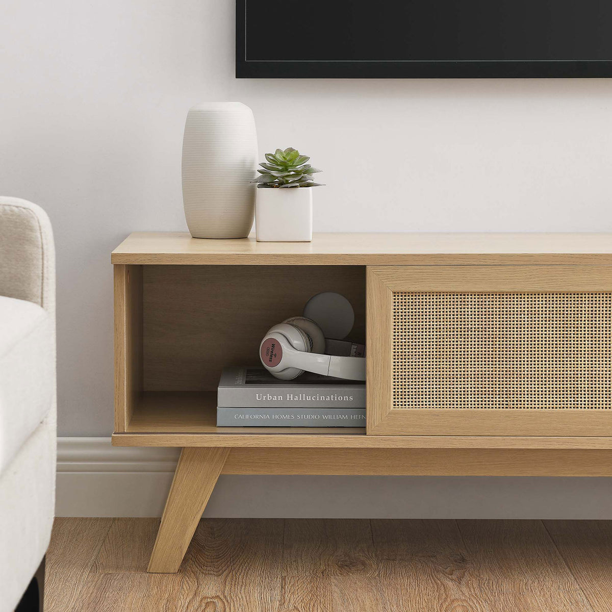Oak tv stand with open storage cubby styled with books and headphones || EEI-6039-OAK || storage_room