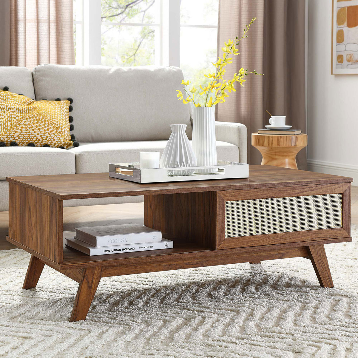 Versatile centerpiece table elevating a living room with warm walnut finish and airy rattan accent || EEI-6041-WAL || front_angle_room