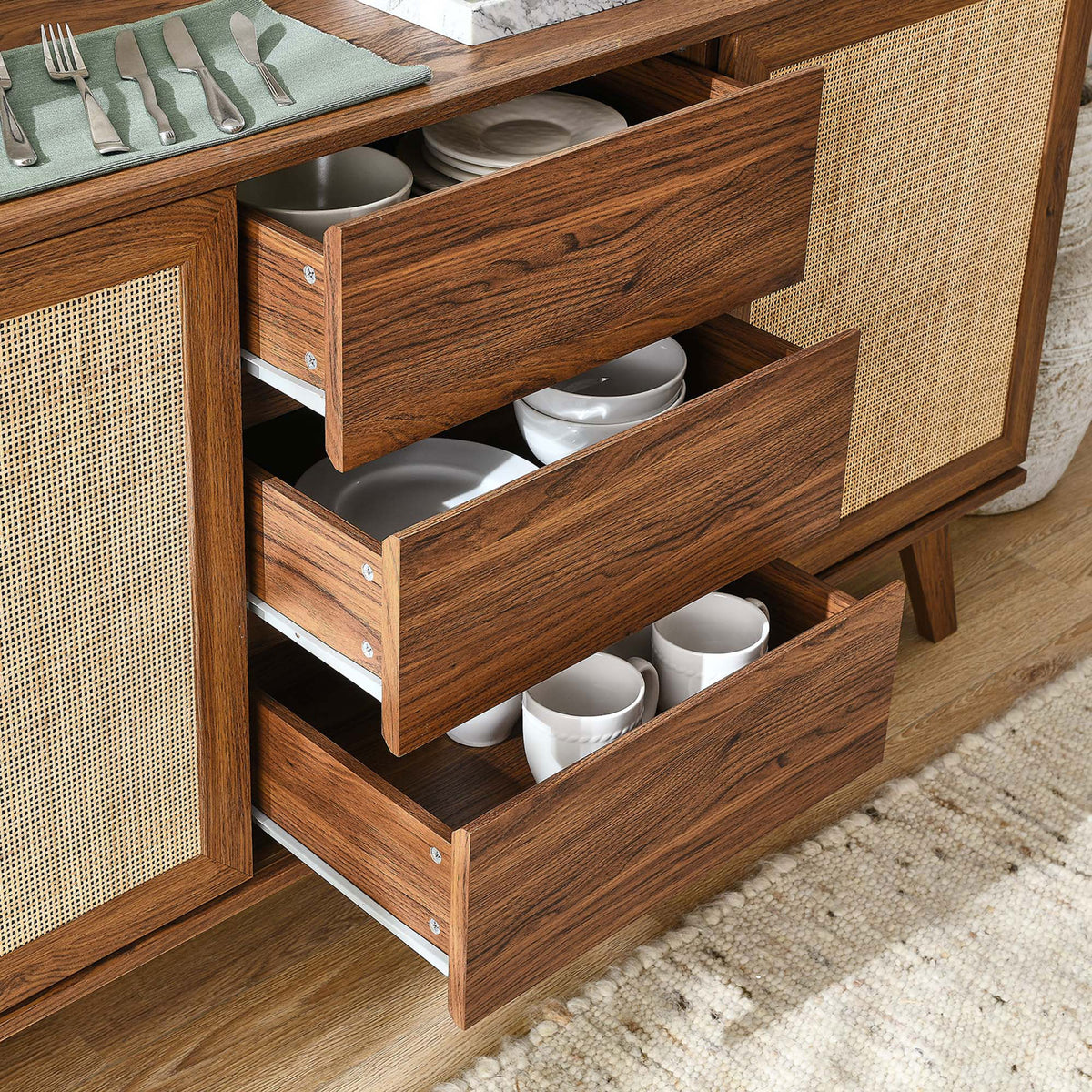 Three center drawers pulled open and filled with dishes to demonstrate generous storage capacity || EEI-6043-WAL || storage_open_room