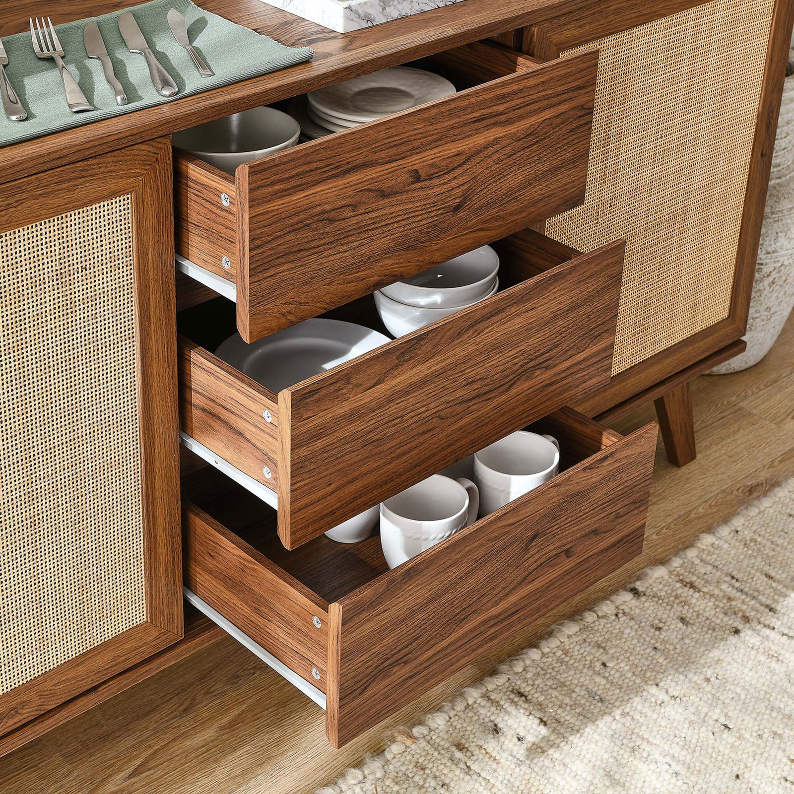 Three center drawers pulled open and filled with dishes to demonstrate generous storage capacity || EEI-6043-WAL || storage_open_room