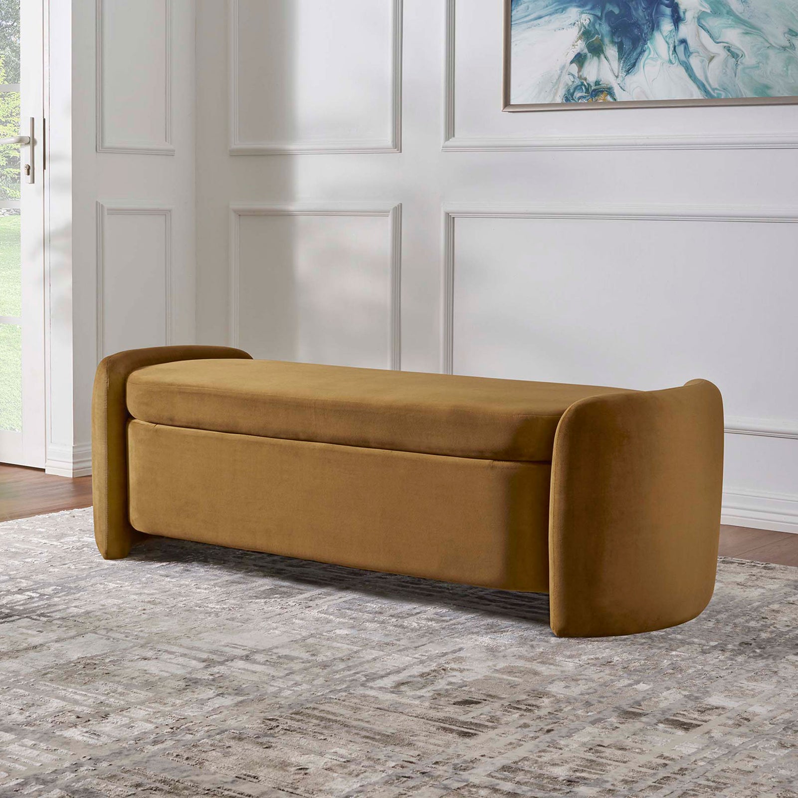 Modern storage bench warms the room in cognac velvet with rounded ends and a clean, low profile. || EEI-6054-COG || front_angle_room