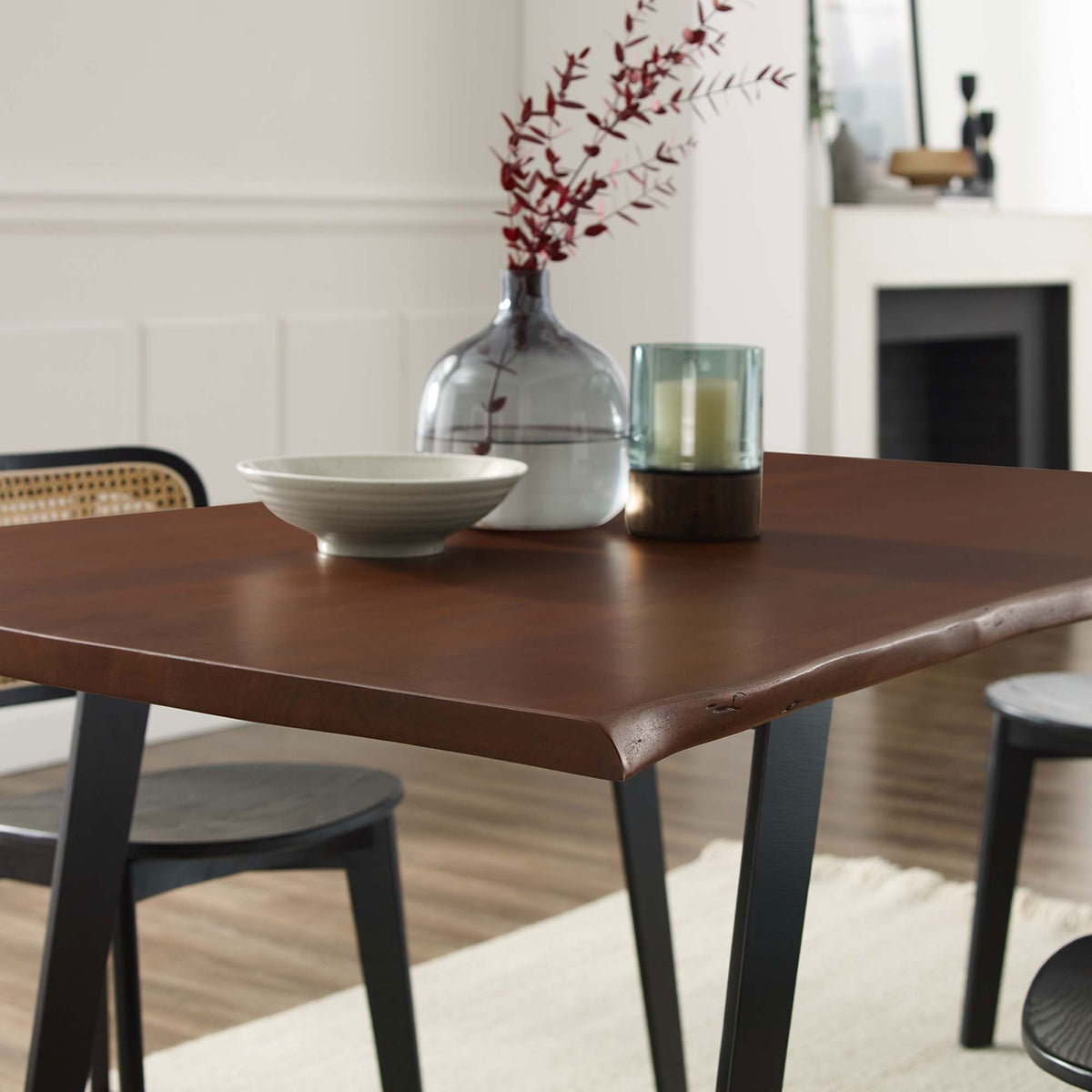 Styled dining scene focuses on the warm live edge tabletop paired with modern black chairs || EEI-6067-BLK-WAL || detail_room