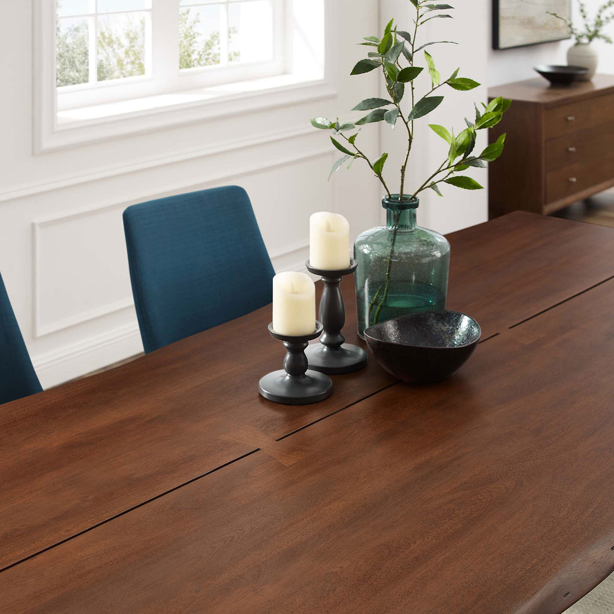 Tabletop styling highlights the rich walnut surface with candles and greenery in a bright room || EEI-6071-BLK-WAL || detail_room