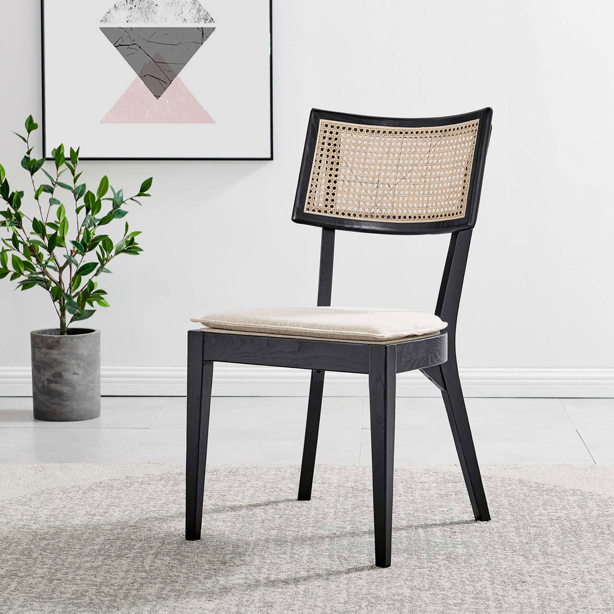 Black and beige dining chair styled in a modern room with artwork, rug, and greenery accents || EEI-6080-BLK-BEI || front_angle_room