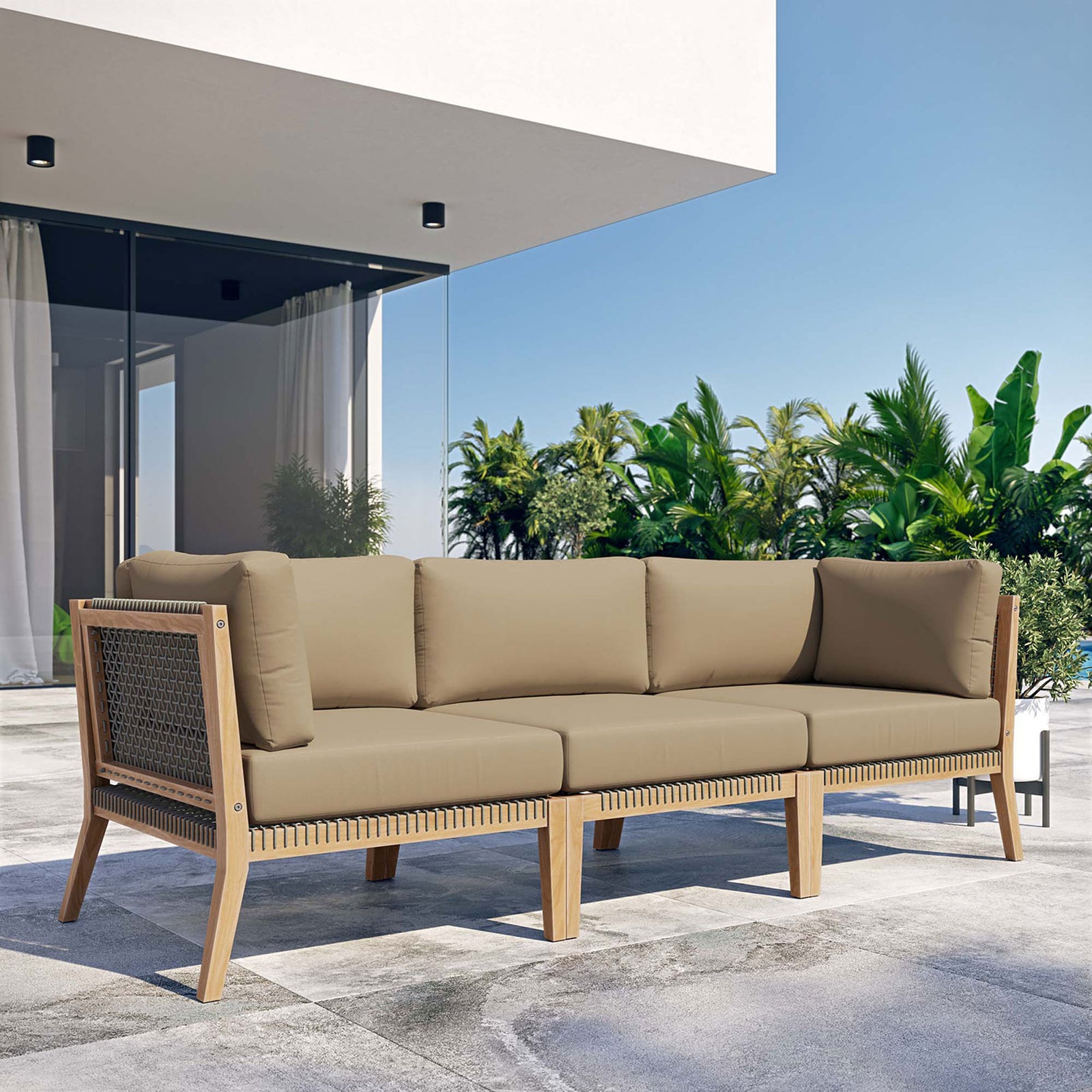 Light brown teak outdoor sofa creating a modern lounge on a sunny patio || EEI-6120-GRY-LBR || front_angle_room