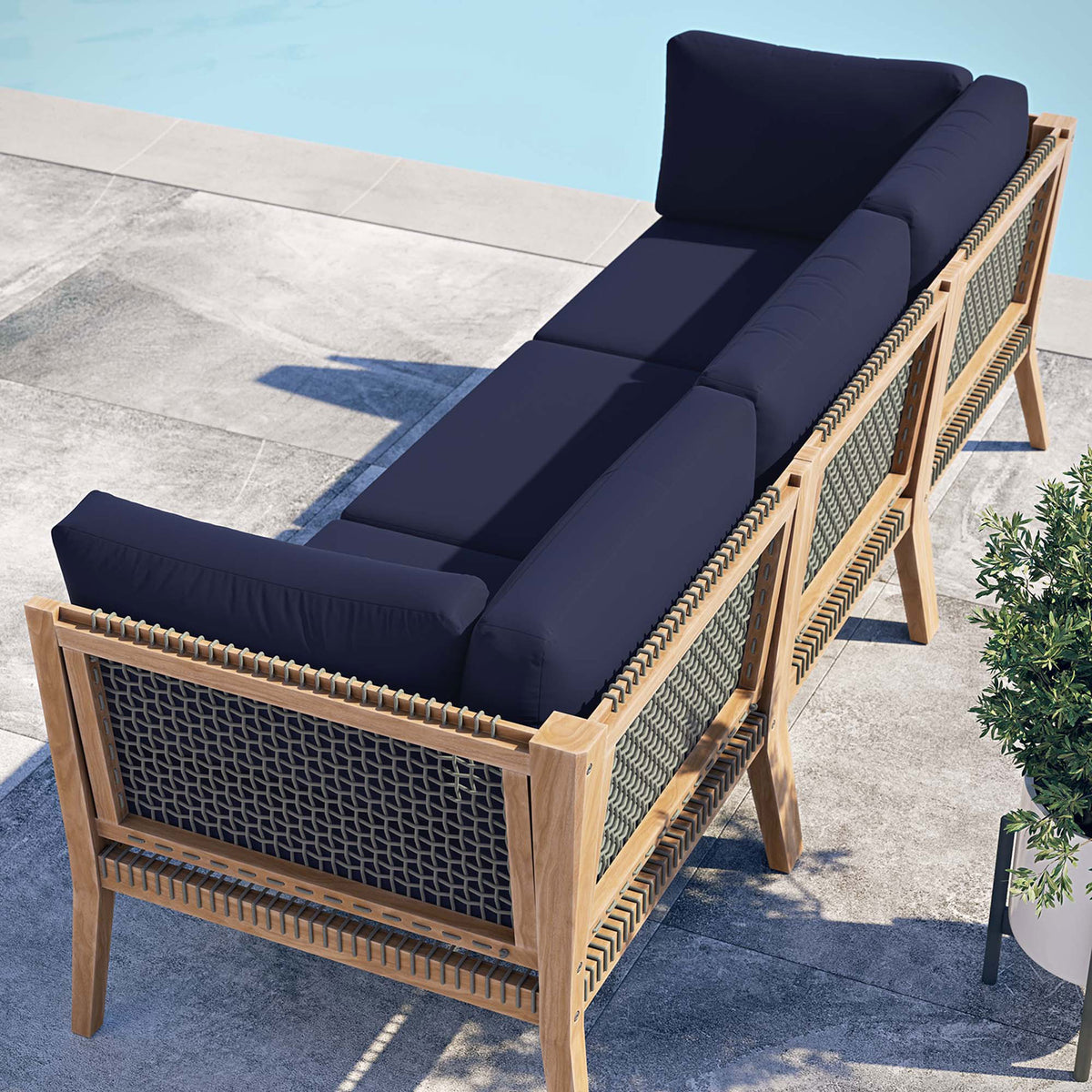 Navy blue outdoor sofa poolside showing rope back panels and teak frame || EEI-6120-GRY-NAV || back_angle_room