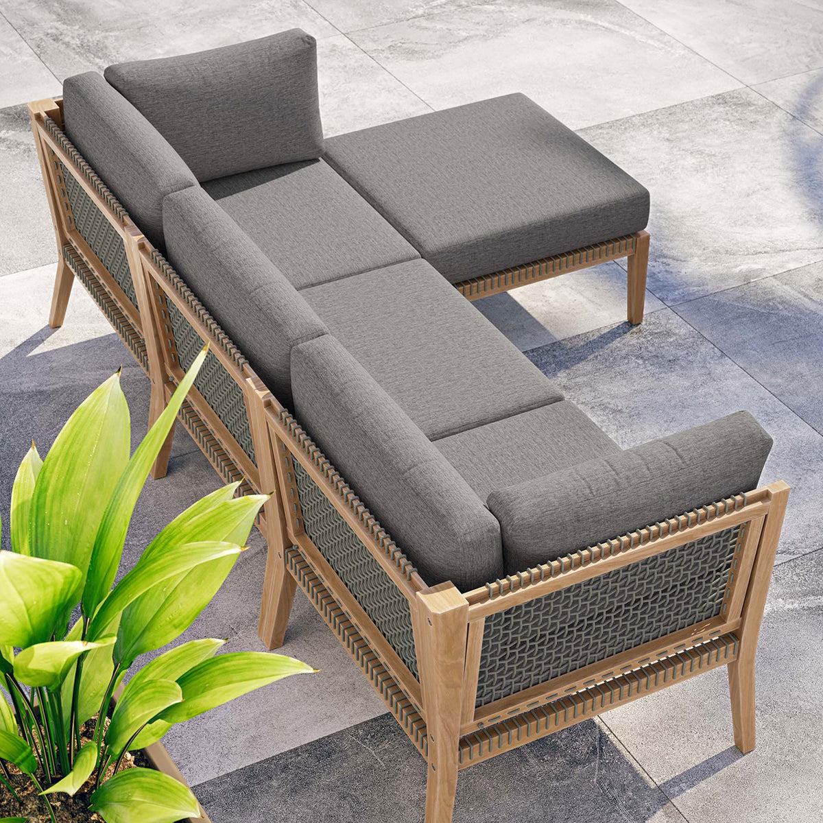 Graphite gray Clearwater sectional arranged poolside to create a relaxing outdoor lounge nook || EEI-6121-GRY-GPH || top_angle_room