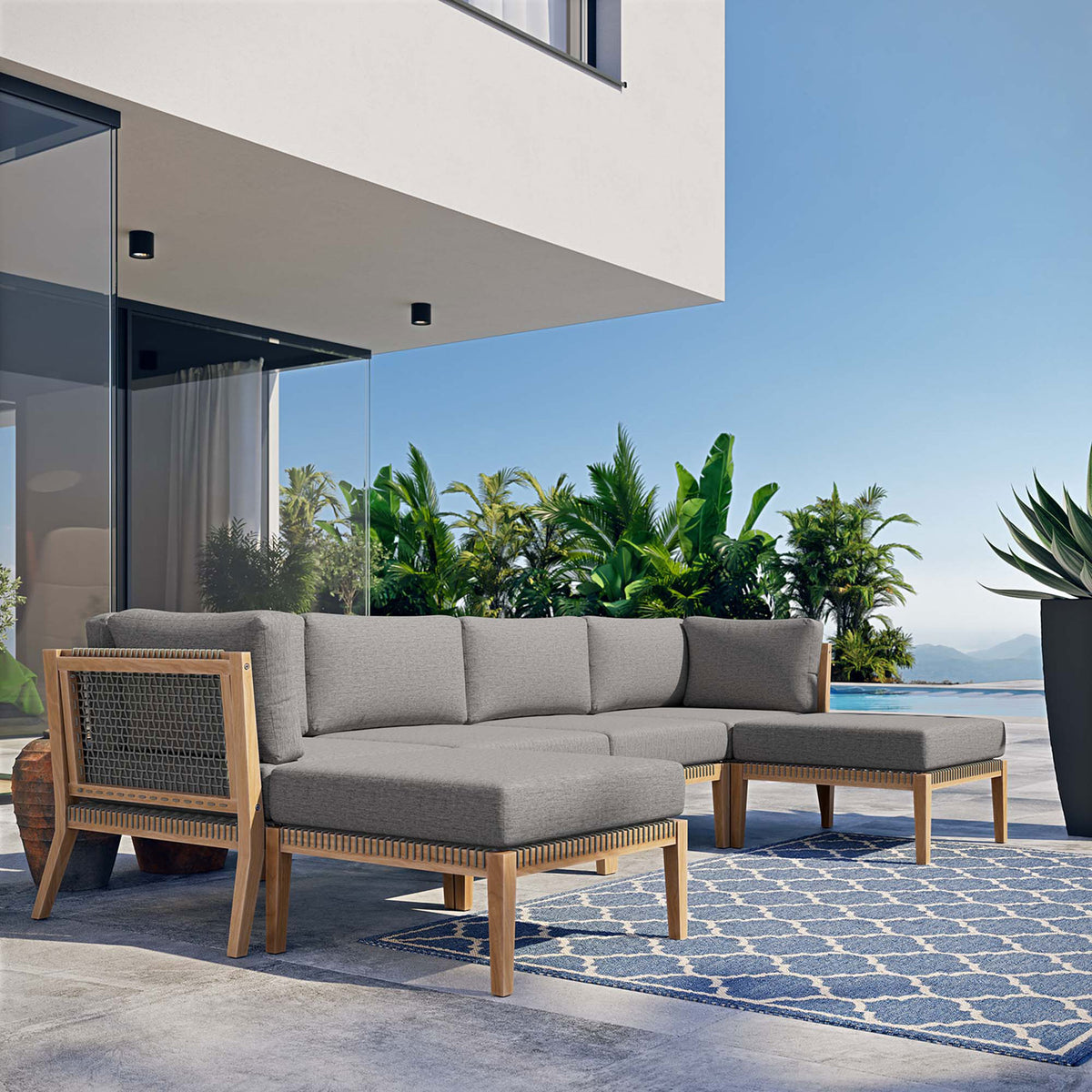 Graphite gray outdoor teak sectional creating a cozy lounge area on a sunlit poolside terrace || EEI-6122-GRY-GPH || front_angle_room
