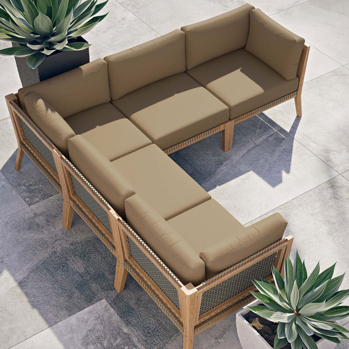 Sunny patio scene with light brown sectional arranged in an inviting L shape beside sculptural planters || EEI-6123-GRY-LBR || top_angle_room