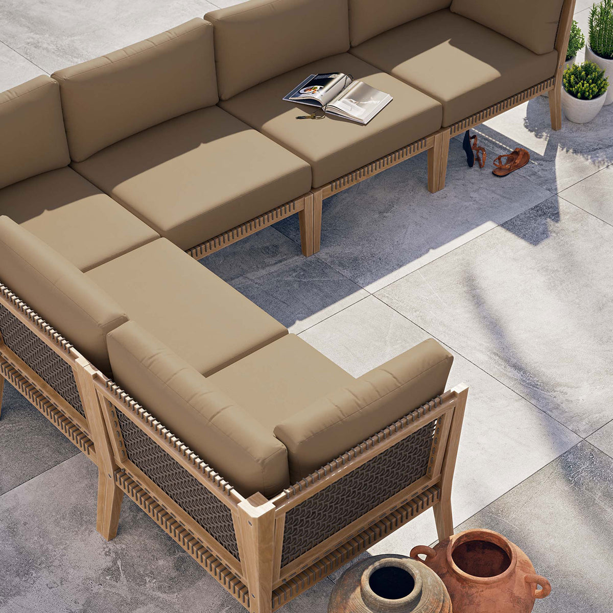Light brown sectional arranged on a modern patio with open book and decor accessories || EEI-6125-GRY-LBR || top_angle_room