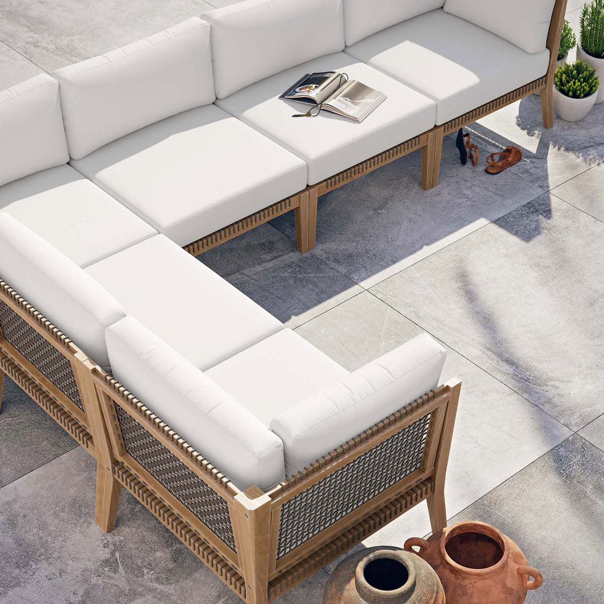White sectional arranged on a modern patio with open book and decor accessories || EEI-6125-GRY-WHI || top_angle_room