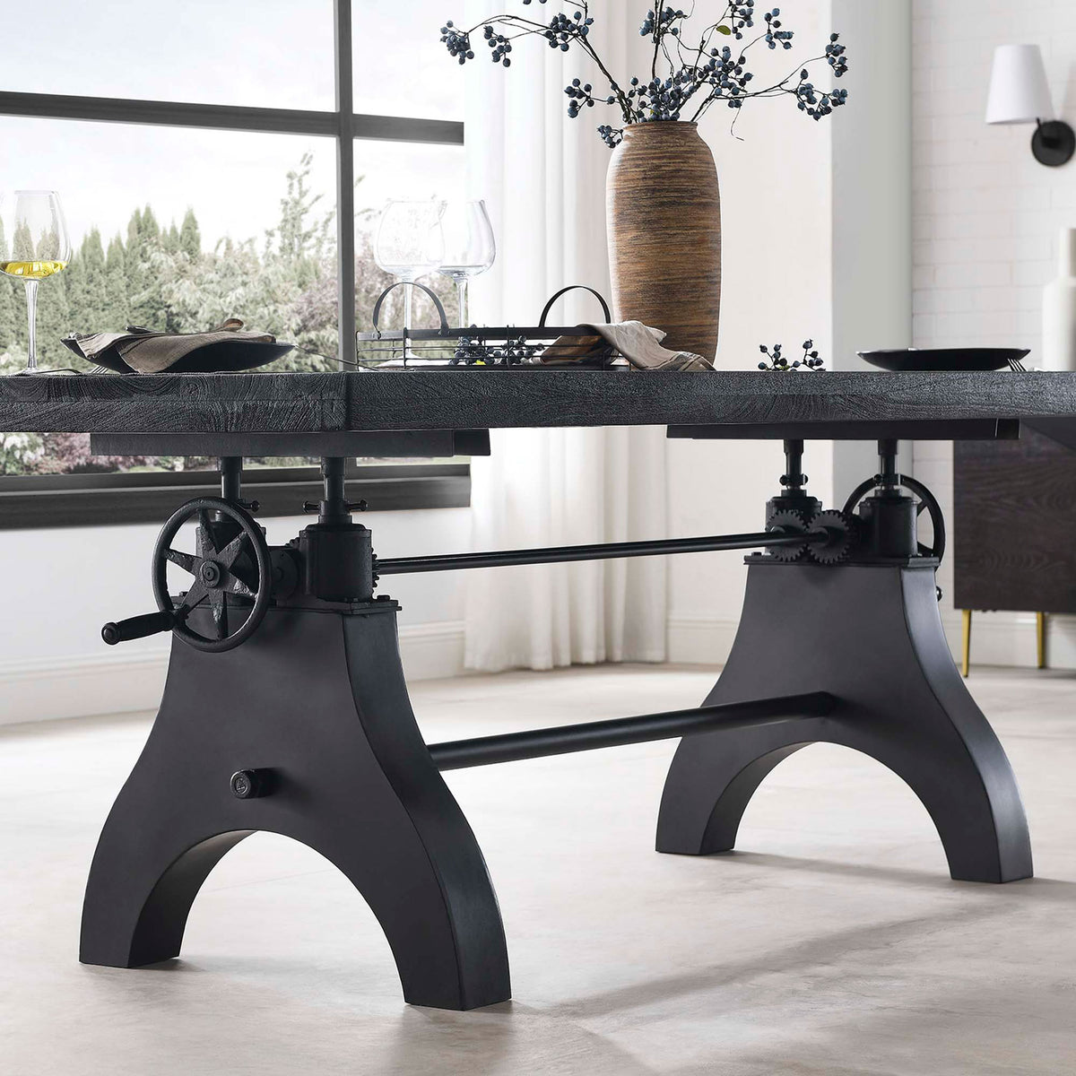 Black crank dining table styled with woven chairs, glassware, and decor in a bright modern dining room || EEI-6149-BLK-BLK || detail_room