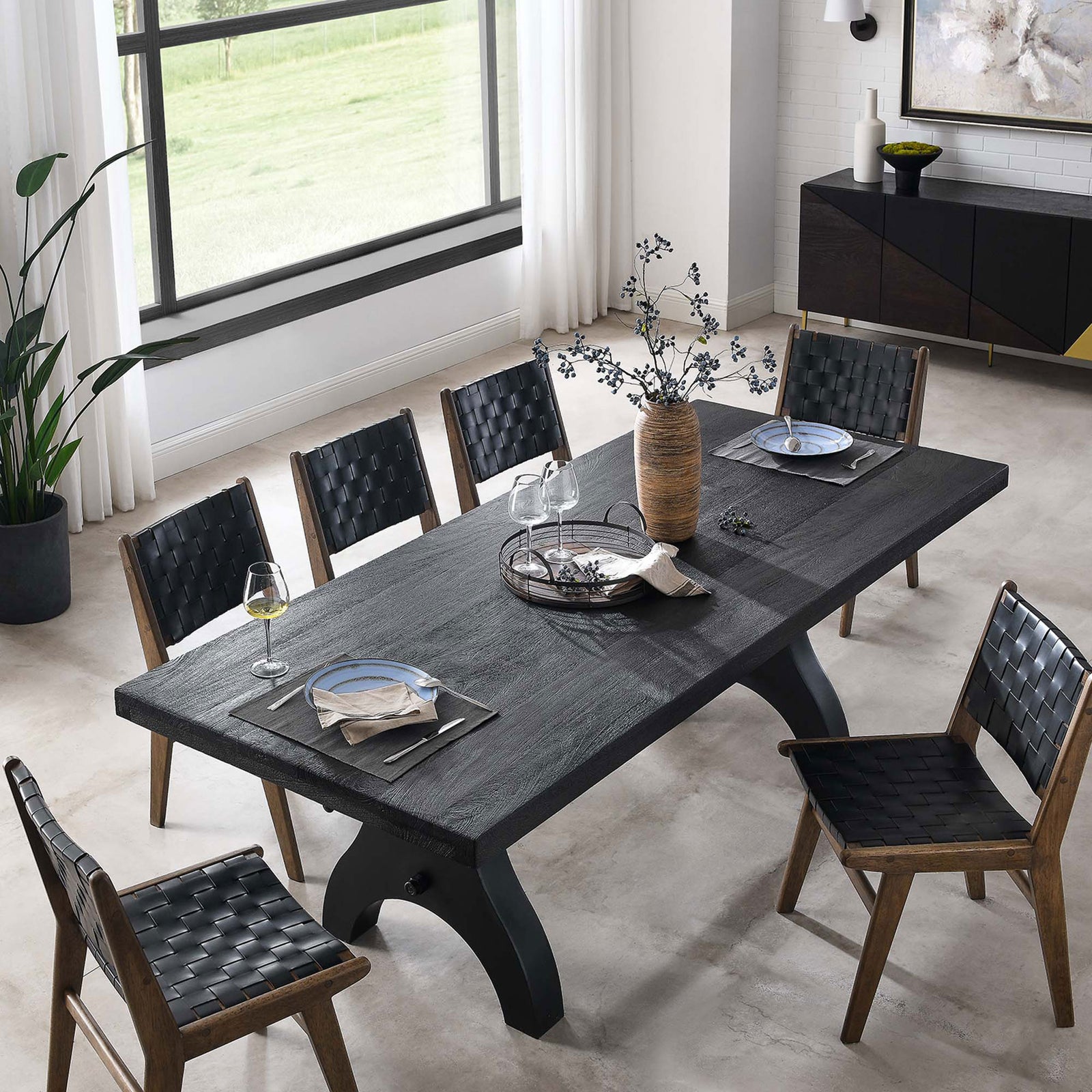 Black rectangular dining table set for six with woven chairs, dinnerware, and natural centerpiece arrangement || EEI-6149-BLK-BLK || top_angle_room