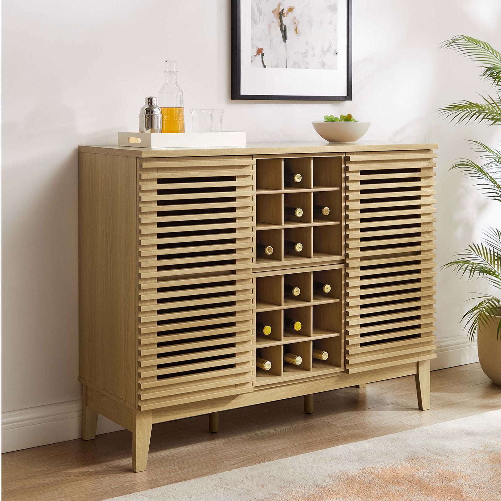 Warm oak cabinet adds mid-century style with slatted doors and splayed legs || EEI-6156-OAK || front_angle_room