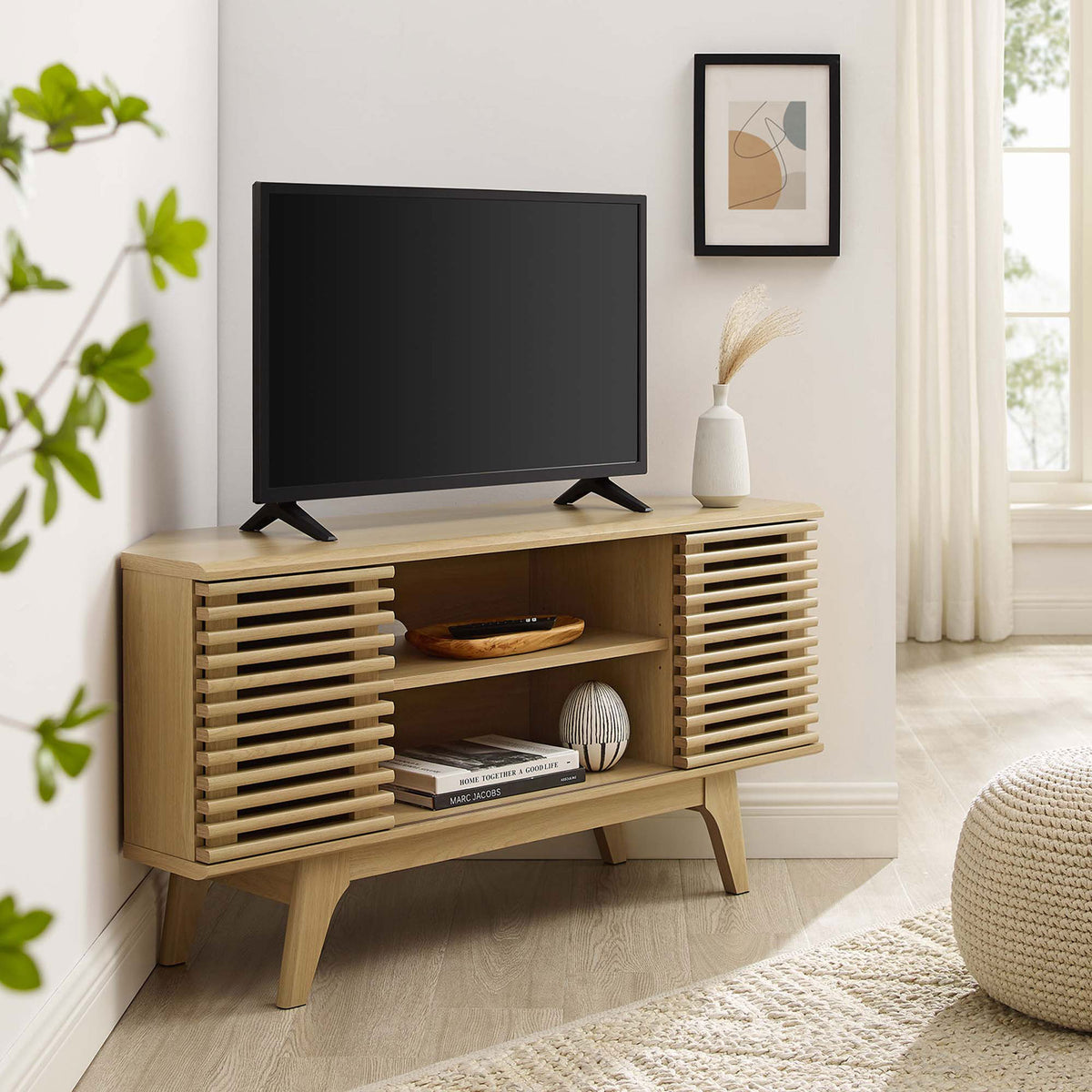 Oak corner TV stand with TV and decor warms a bright living room with mid-century media style || EEI-6157-OAK || front_angle_room