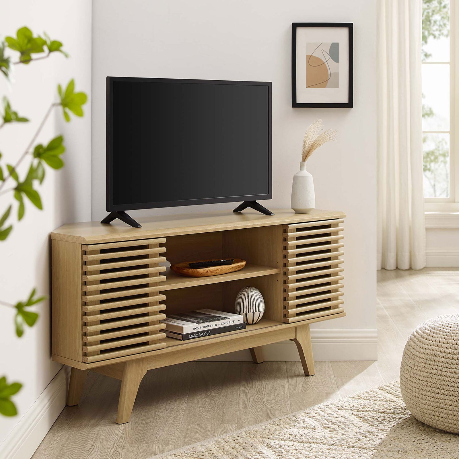 Oak corner TV stand with TV and decor warms a bright living room with mid-century media style || EEI-6157-OAK || front_angle_room