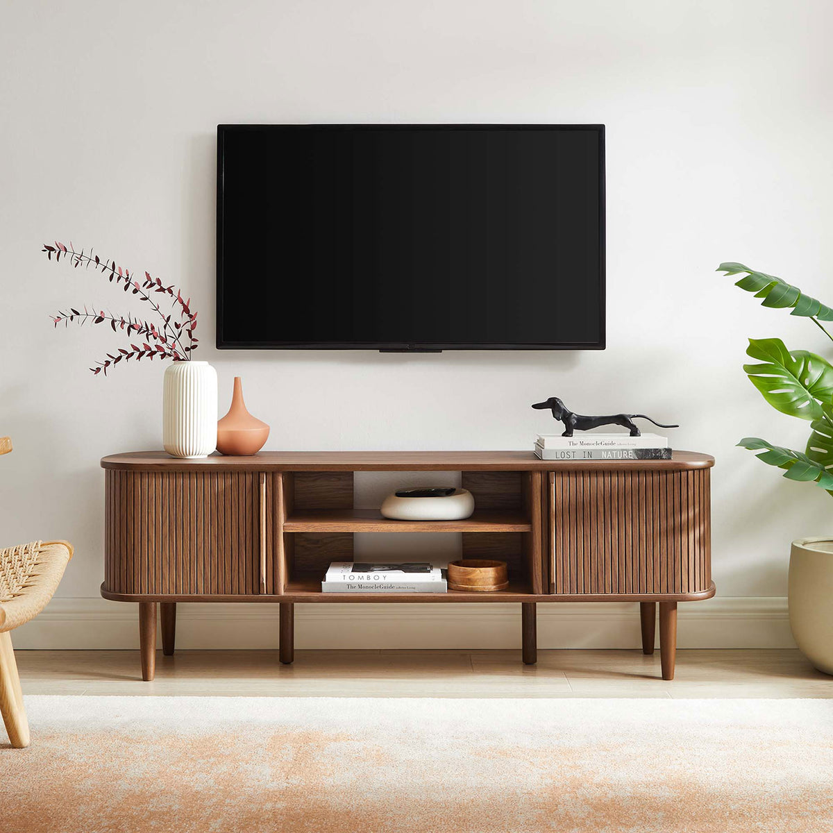 Walnut Contour TV stand styled with decor in a contemporary living room setting || EEI-6158-WAL || front_room