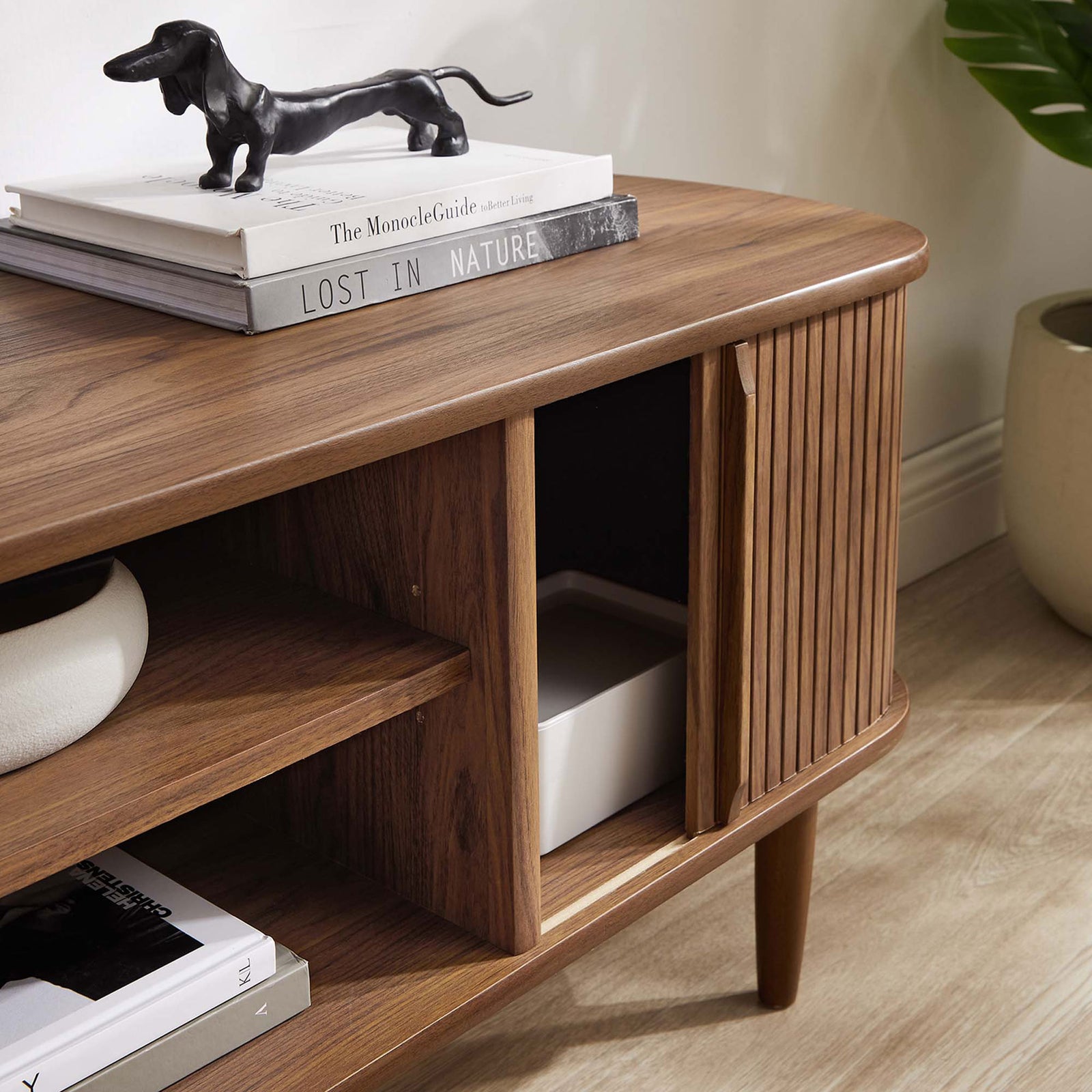 Sliding door reveals hidden storage inside the walnut TV stand for clutter-free living || EEI-6158-WAL || storage_open_room
