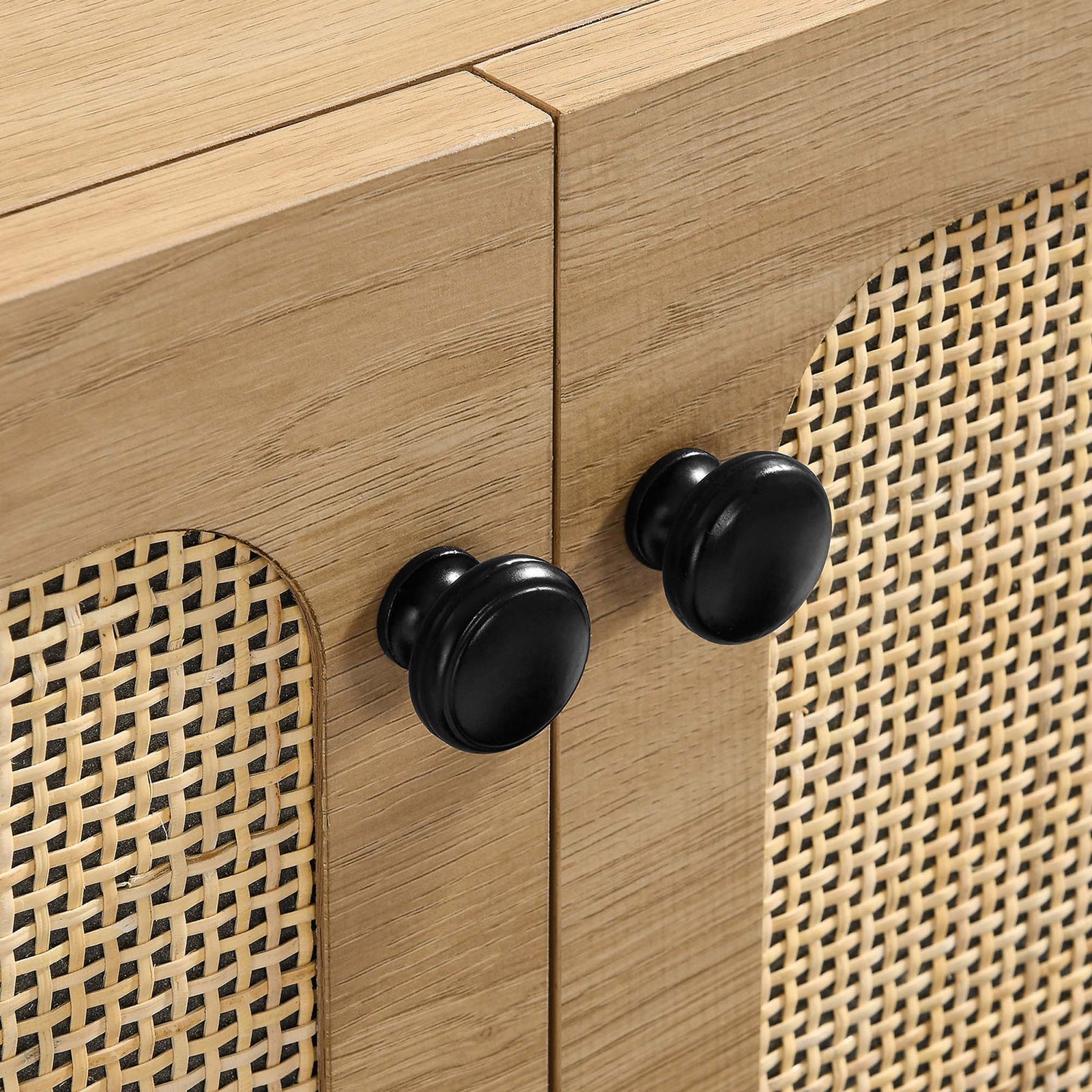 Matte black door knobs contrasted against warm oak grain and woven cane fronts || EEI-6200-OAK || handle_studio