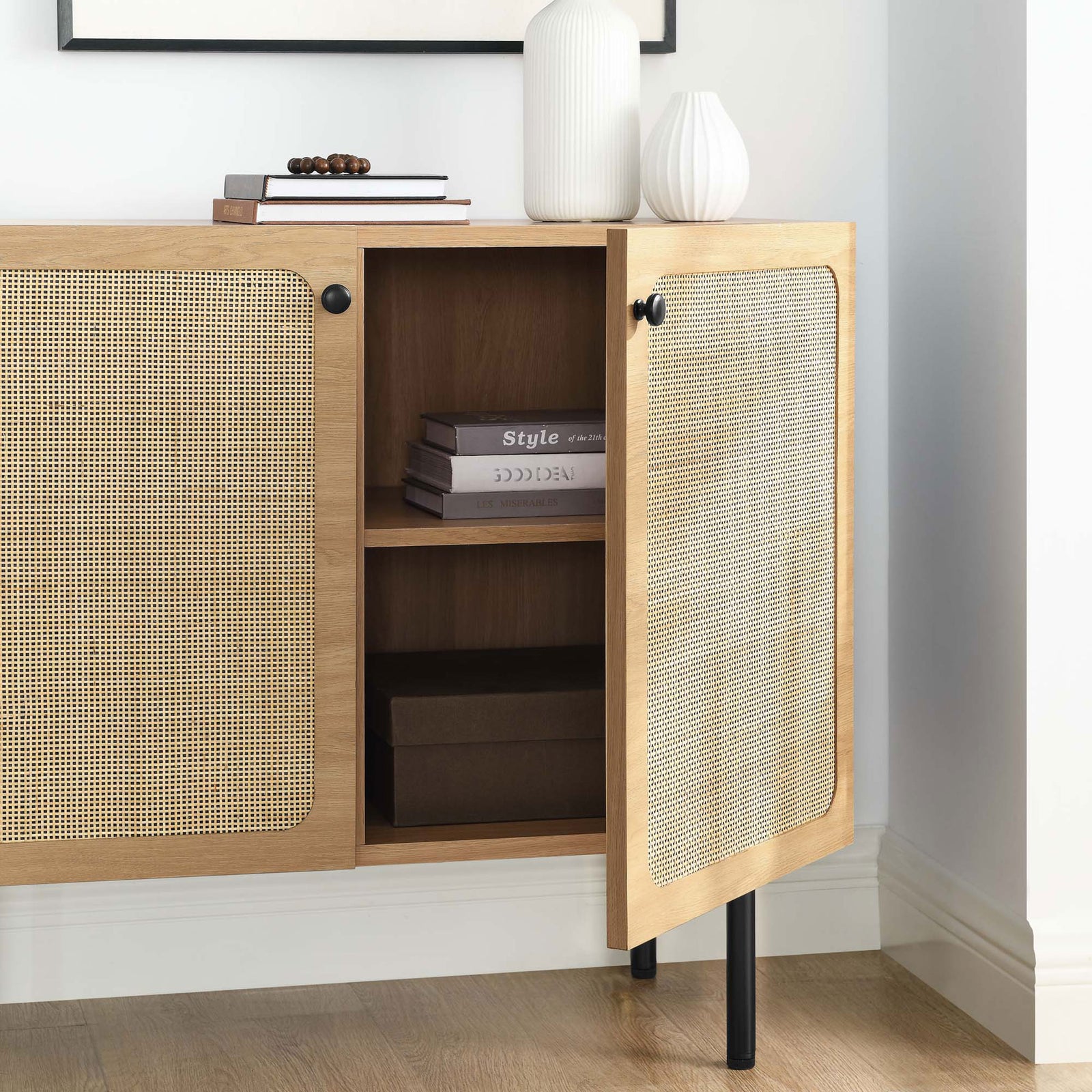 Open oak cabinet in a modern room scene showcasing rattan doors and generous interior storage || EEI-6200-OAK || storage_open_room