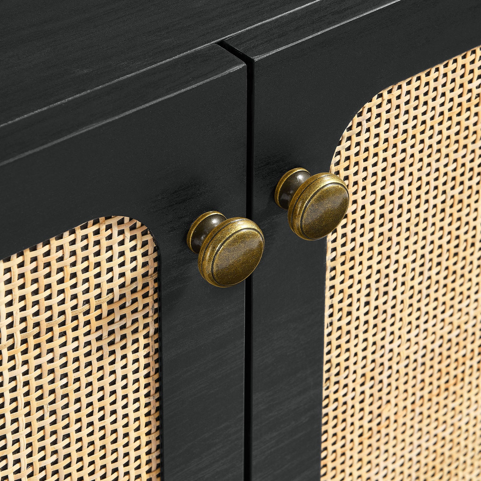 Close-up of round brass knobs against black frame and natural rattan doors on the Chaucer sideboard || EEI-6201-BLK || handle_studio