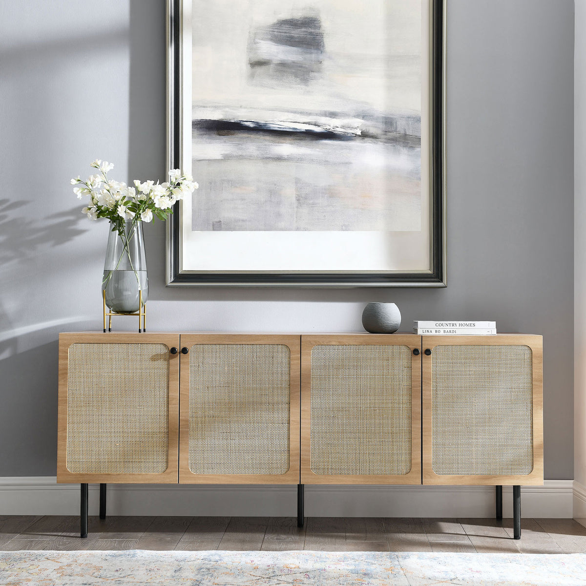 Oak sideboard styled in a modern living space with framed art, decor accents, and area rug || EEI-6201-OAK || front_angle_room