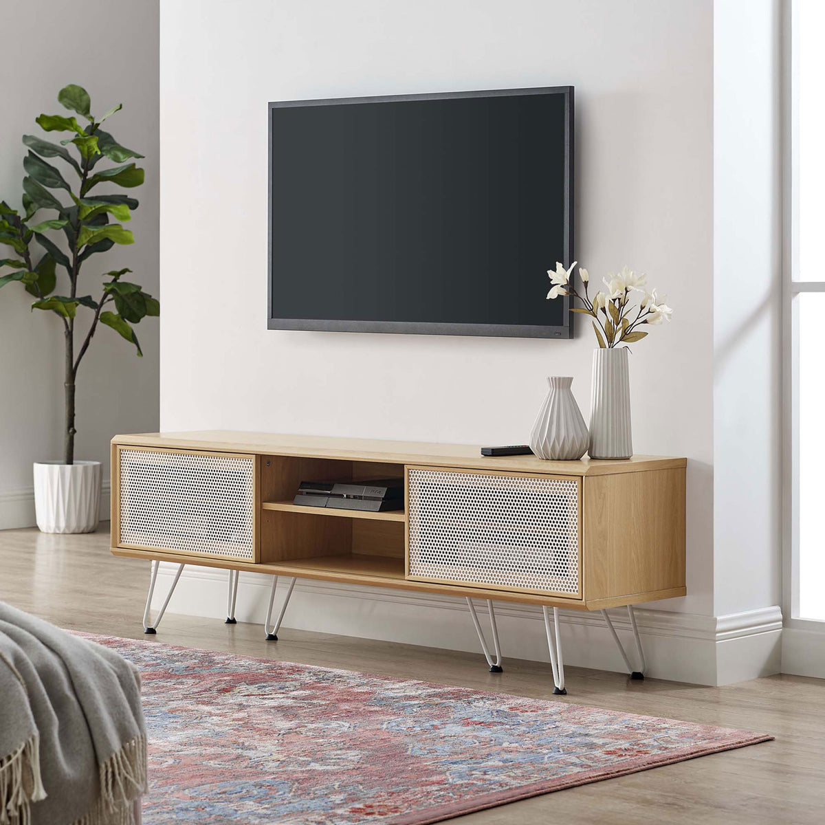 Oak 59 inch TV stand with white mesh doors and hairpin legs styled in a bright modern living room || EEI-6203-OAK || front_angle_room