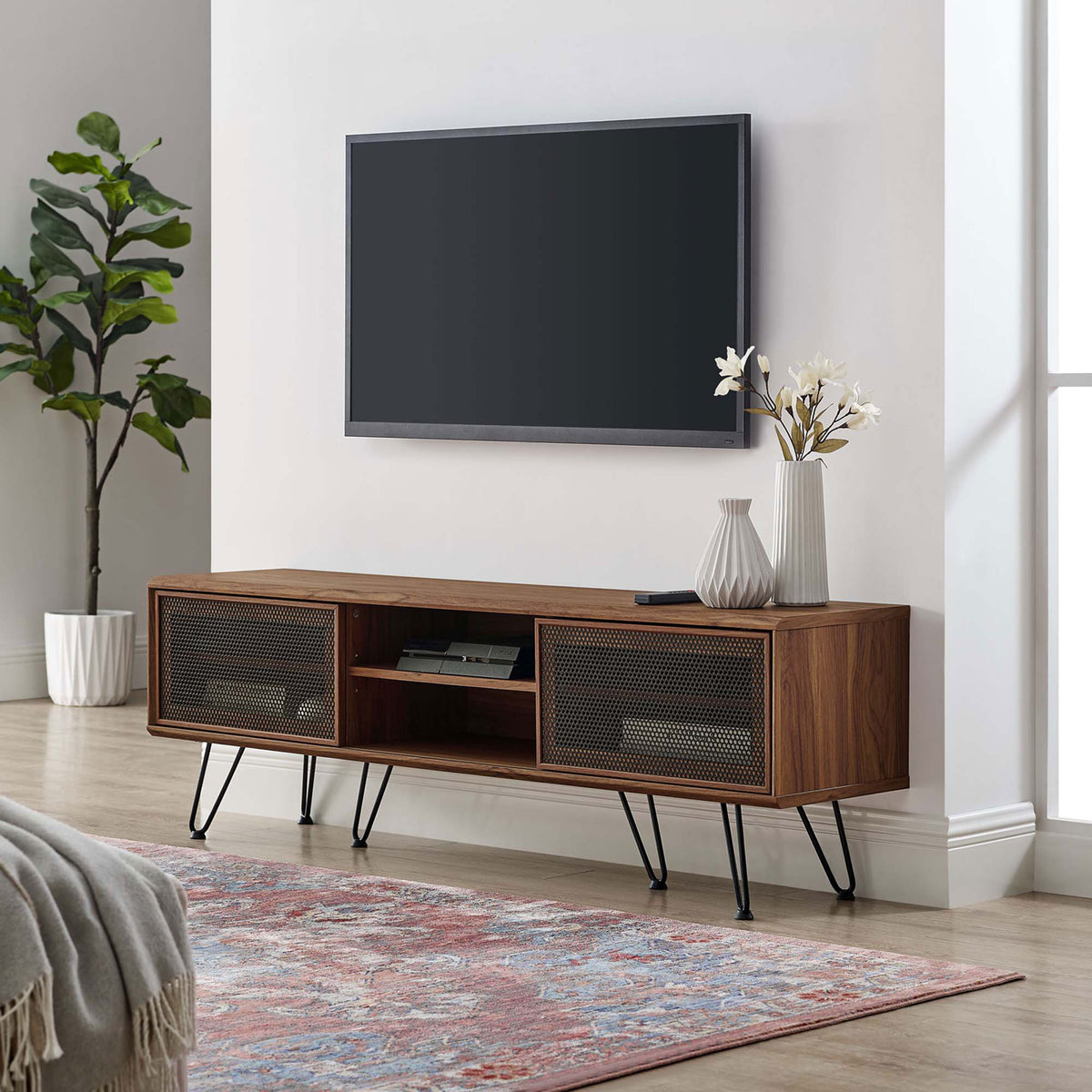 Walnut 59 inch TV stand with black mesh doors and hairpin legs in a bright contemporary living room || EEI-6203-WAL || front_angle_room