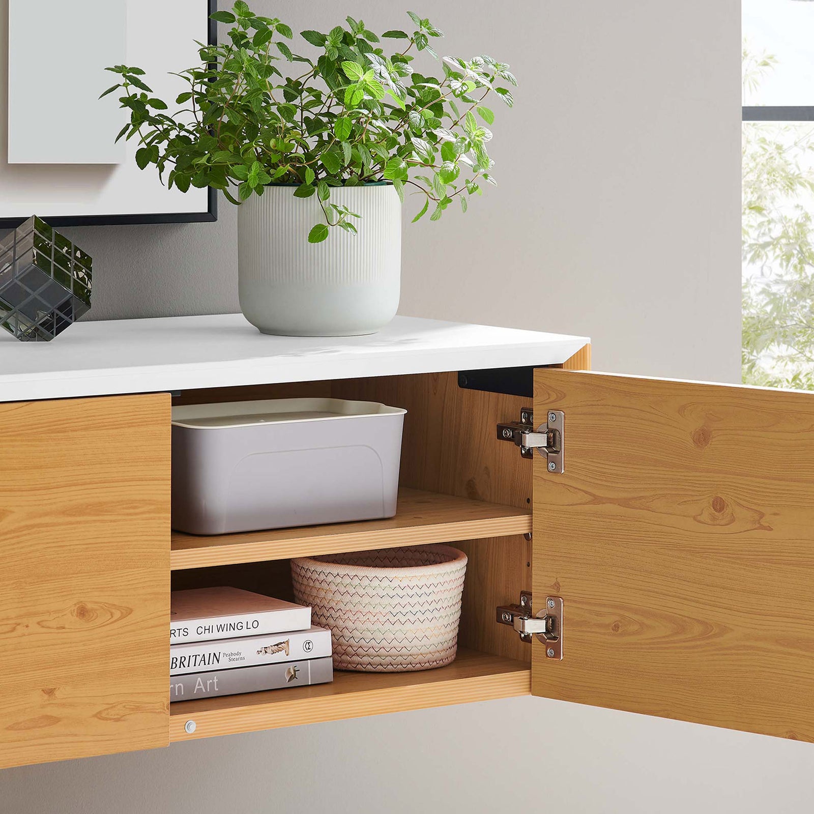 Wall cabinet interior styled with books and baskets on natural wood shelf || EEI-6205-WHI-NAT || storage_open_room