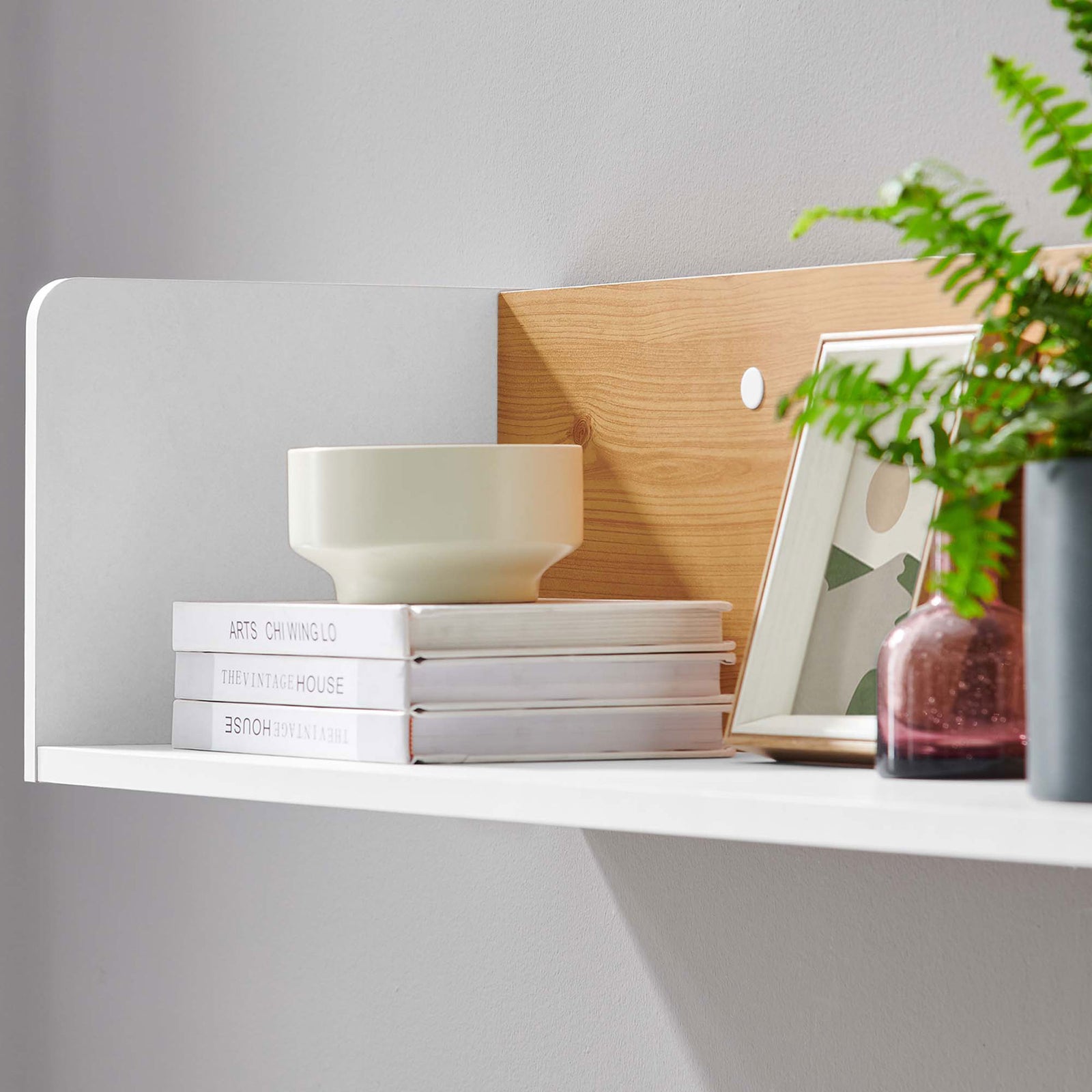 White and natural wall shelf styled with books, ceramics, and greenery to showcase its display potential. || EEI-6208-WHI-NAT || detail_room