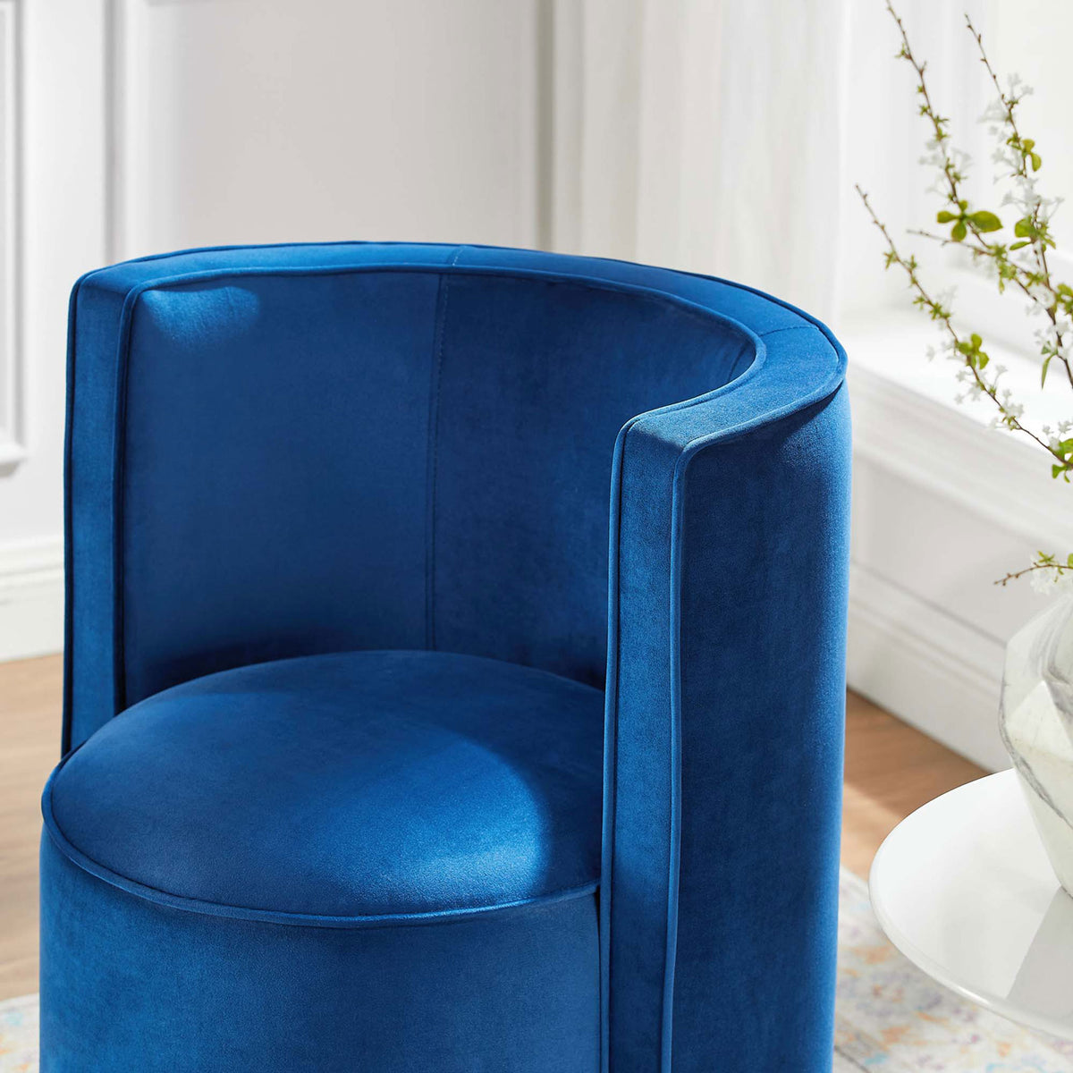 Plush navy velvet seat and curved back with piping detail in a sunlit room || EEI-6222-NAV || detail_room