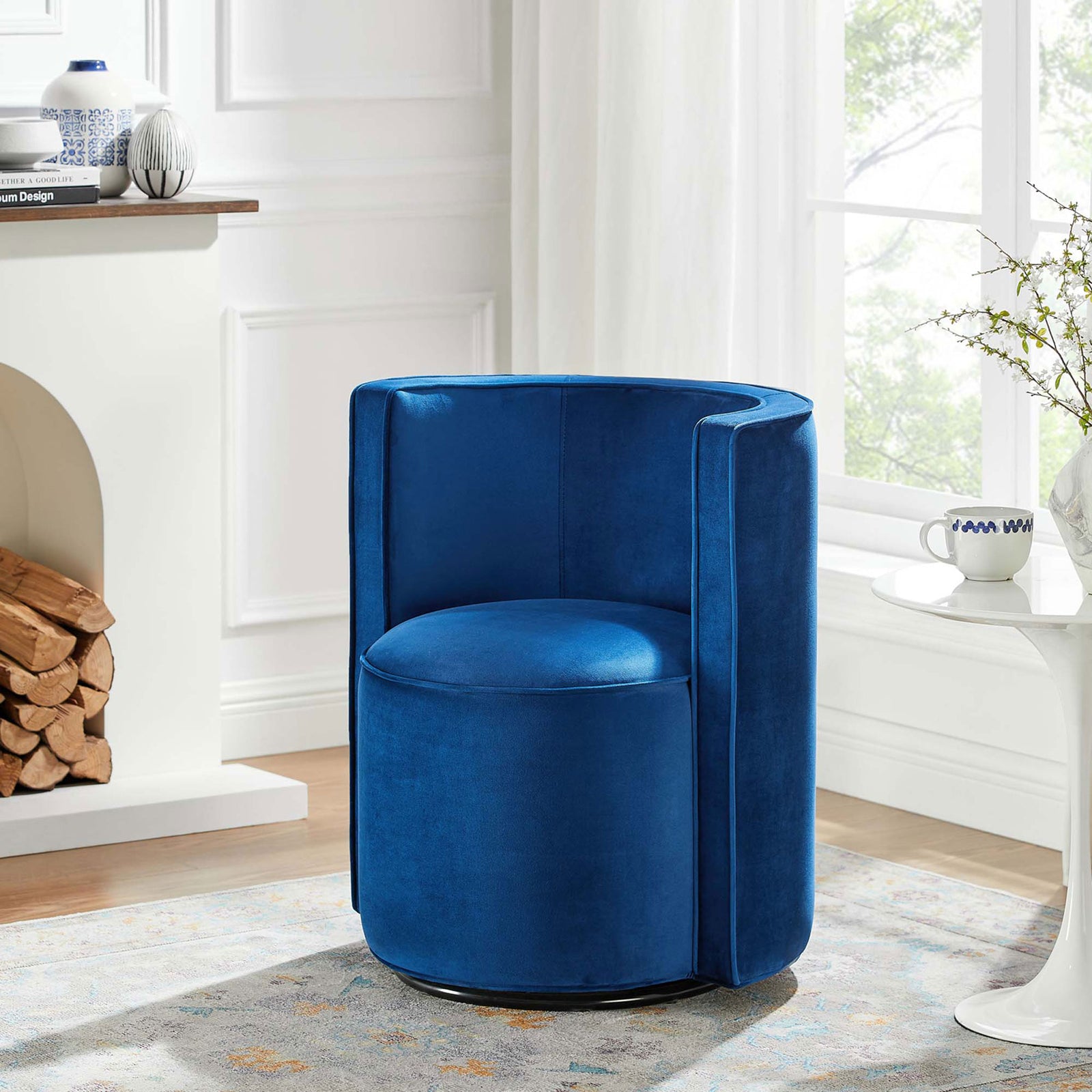 Navy velvet swivel chair adds a pop of color and modern form to a bright, airy living space || EEI-6222-NAV || front_angle_room