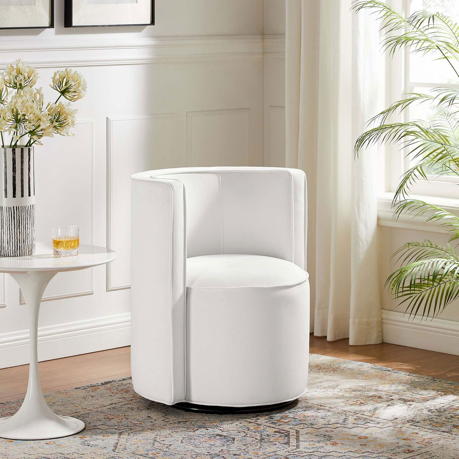 White velvet swivel chair brings modern polish to a bright living room with its rounded form and slim piping || EEI-6222-WHI || front_room
