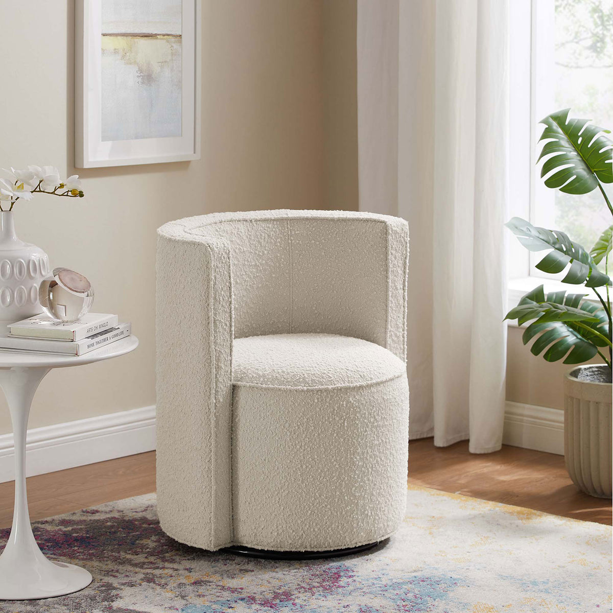 The ivory boucle swivel chair adds soft texture and modern shape to a bright living room. || EEI-6223-IVO || front_angle_room