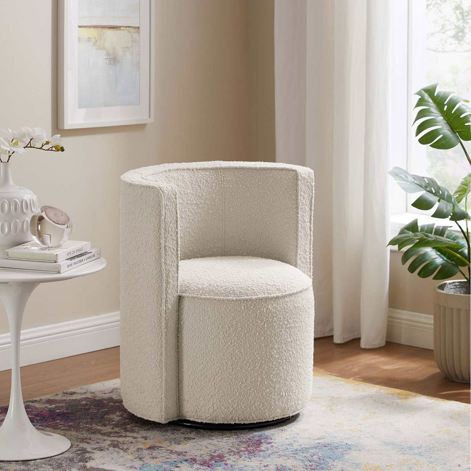 The ivory boucle swivel chair adds soft texture and modern shape to a bright living room. || EEI-6223-IVO || front_angle_room