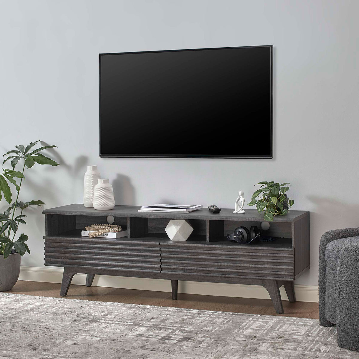 Charcoal TV stand in modern living room holding decor with one drawer open for convenient storage || EEI-6228-CHA || front_angle_open_room