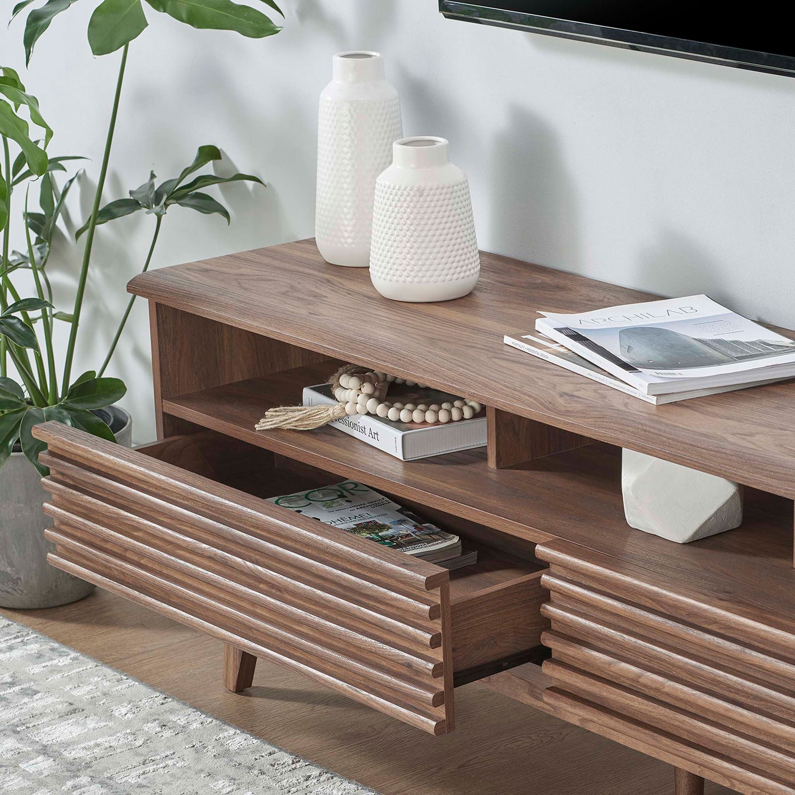 Walnut TV stand styled with decor accents and open drawer storing books and magazines || EEI-6228-WAL || storage_open_room