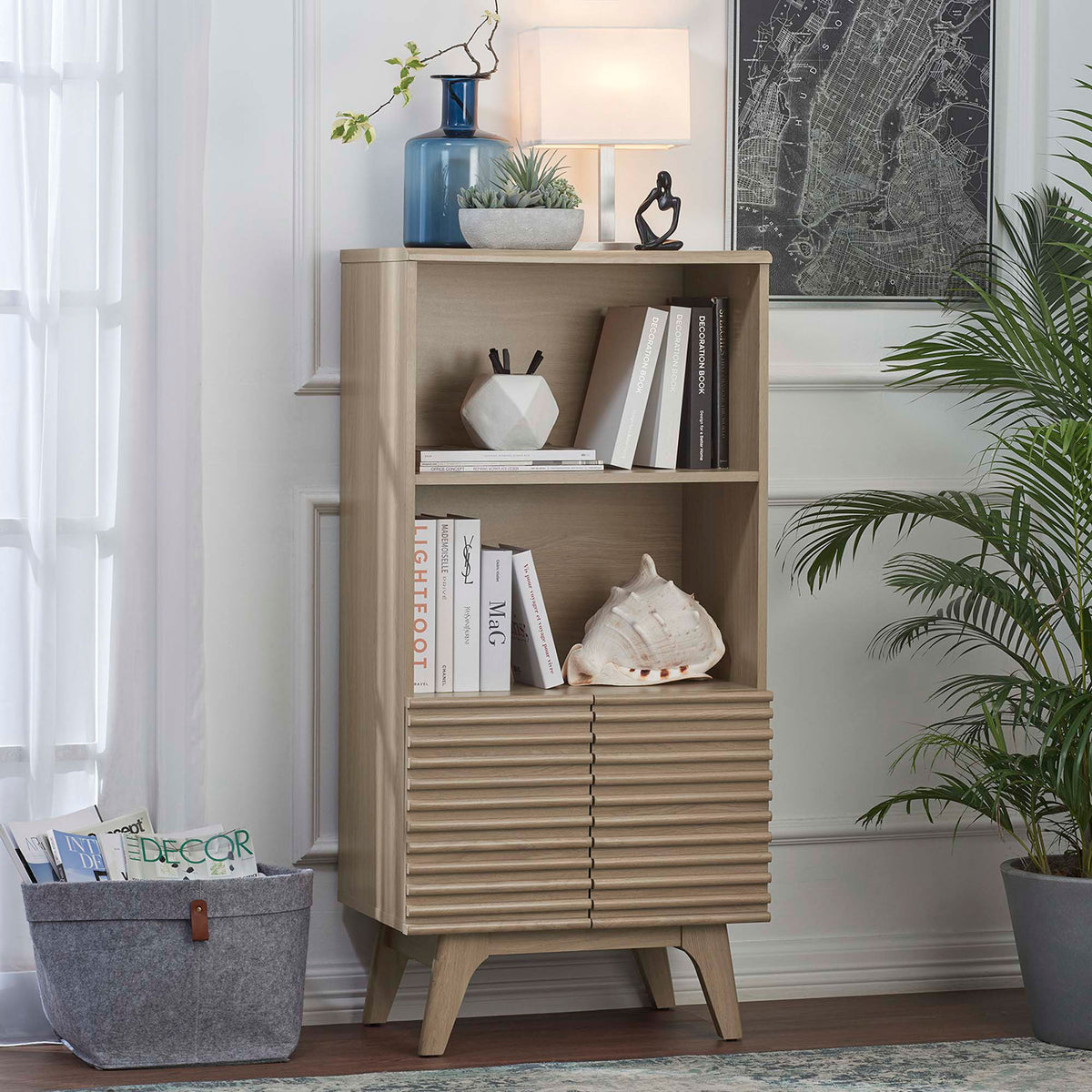 Styled as a living room bookcase with warm oak texture and slatted cabinet doors || EEI-6229-OAK || front_angle_room