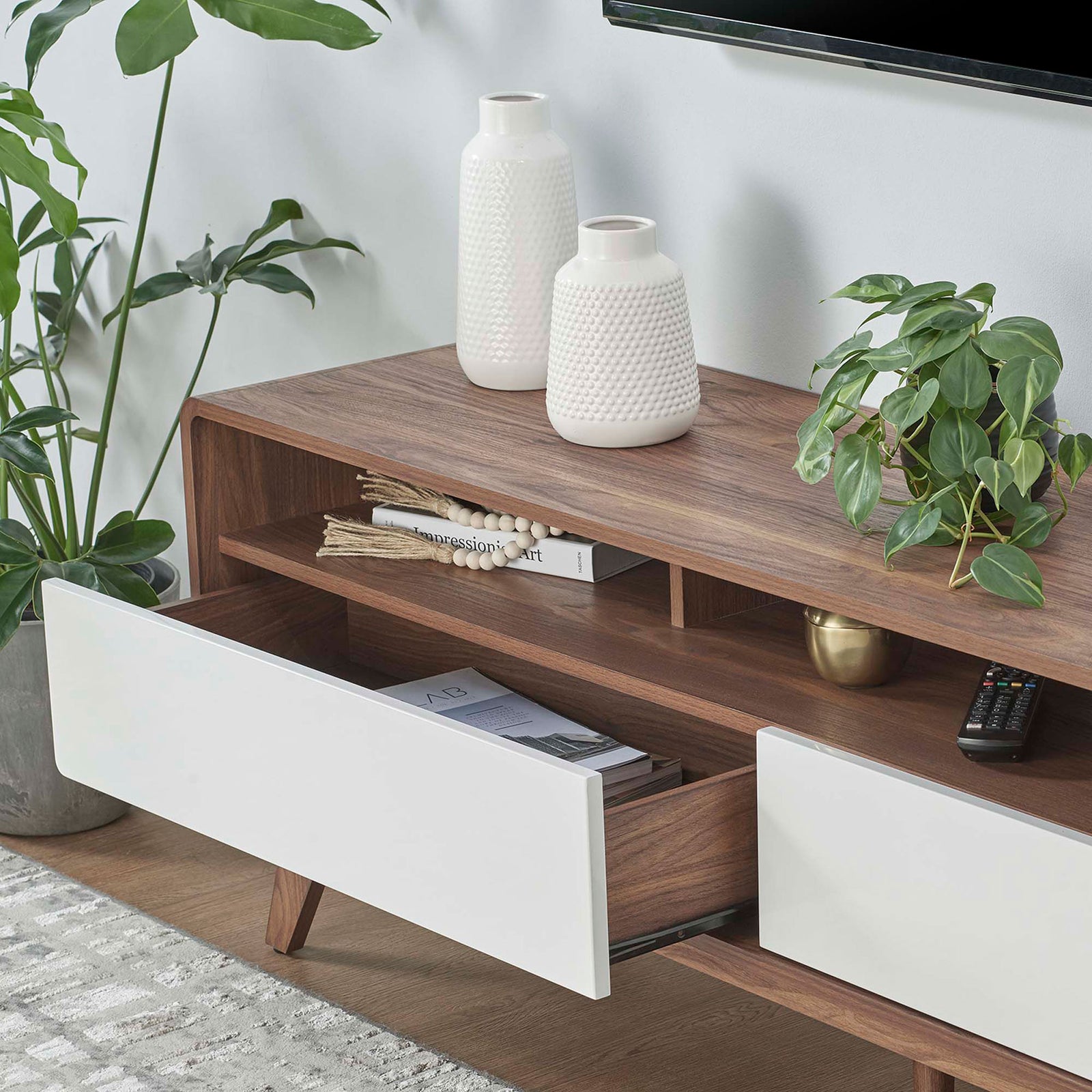 Open drawers keep books and media tucked away while the walnut top displays plants and accessories || EEI-6231-WAL-WHI || storage_open_room