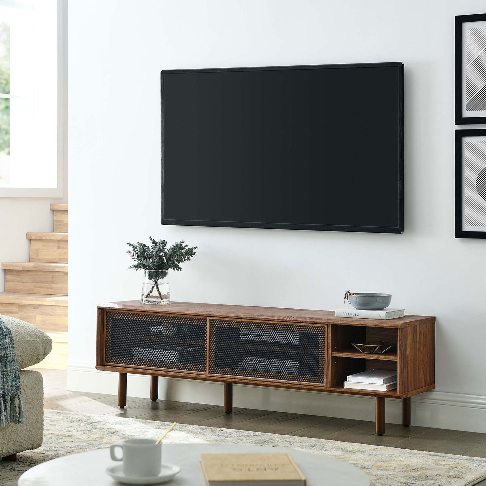 Kurtis 60 in walnut TV stand in a cozy living room beneath a wall-mounted television || EEI-6234-WAL || front_angle_room