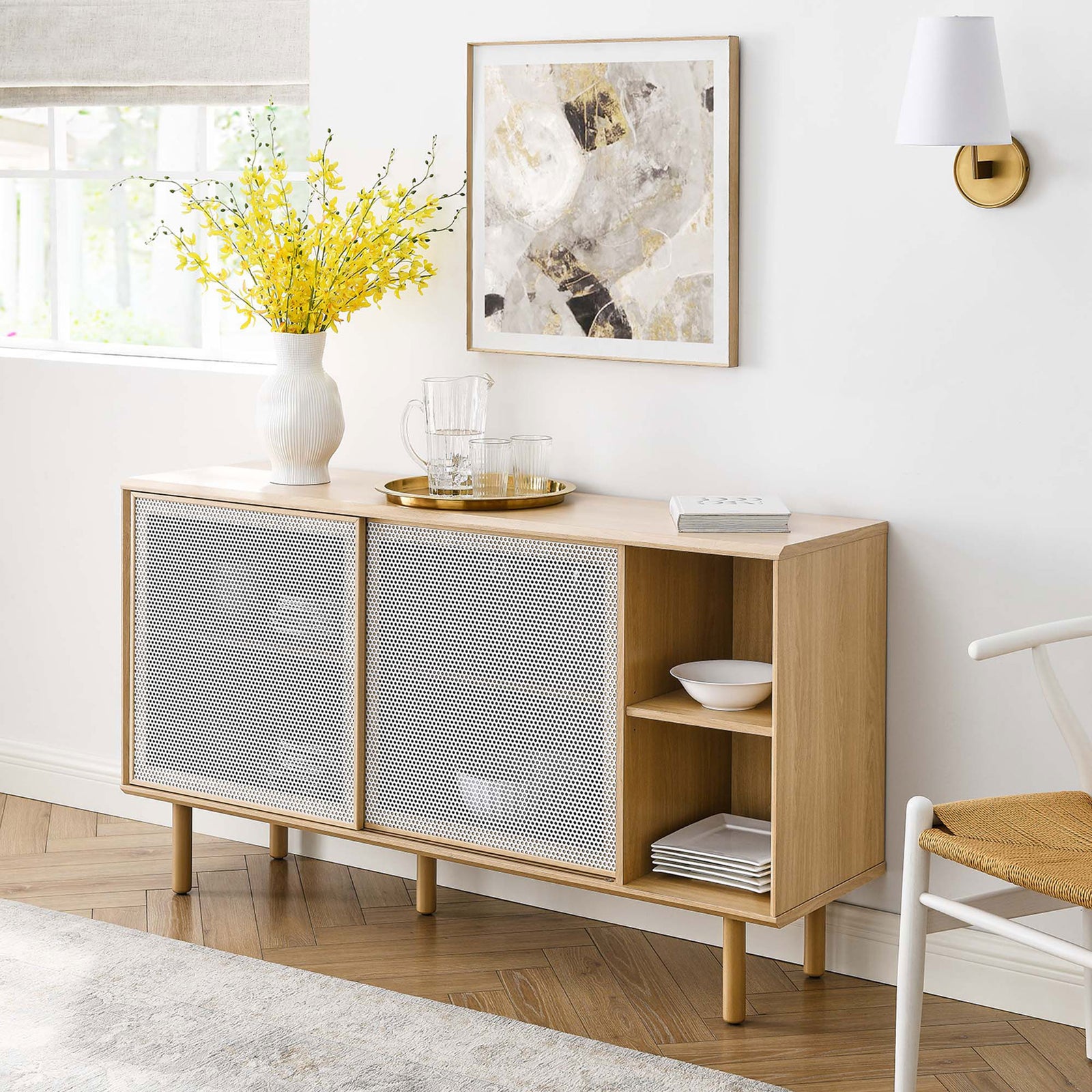 Kurtis oak sideboard styled in a bright living room with decor accents and warm wood flooring. || EEI-6235-OAK || front_room