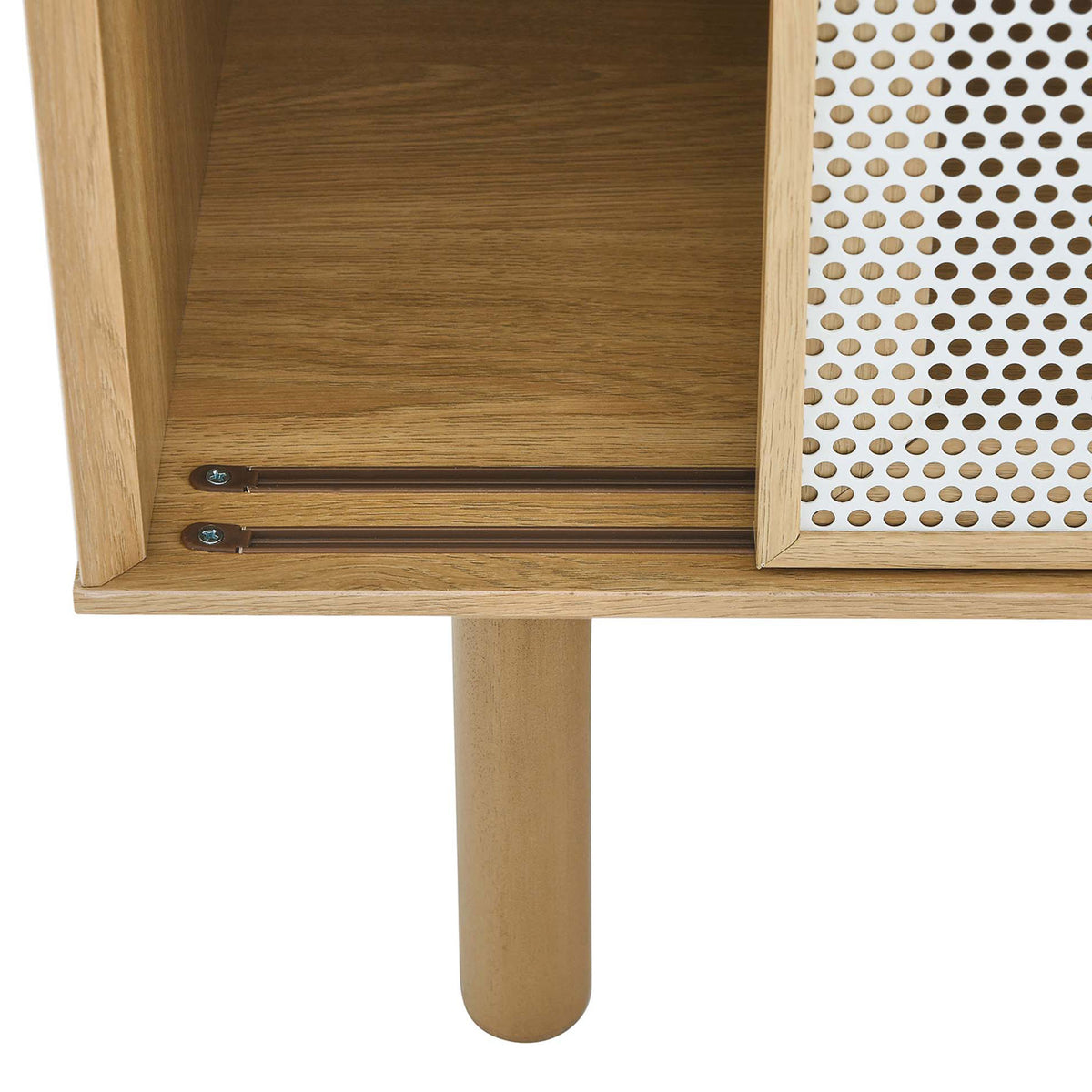 Oak cabinet leg with visible sliding door track and perforated white mesh panel. || EEI-6235-OAK || leg_studio