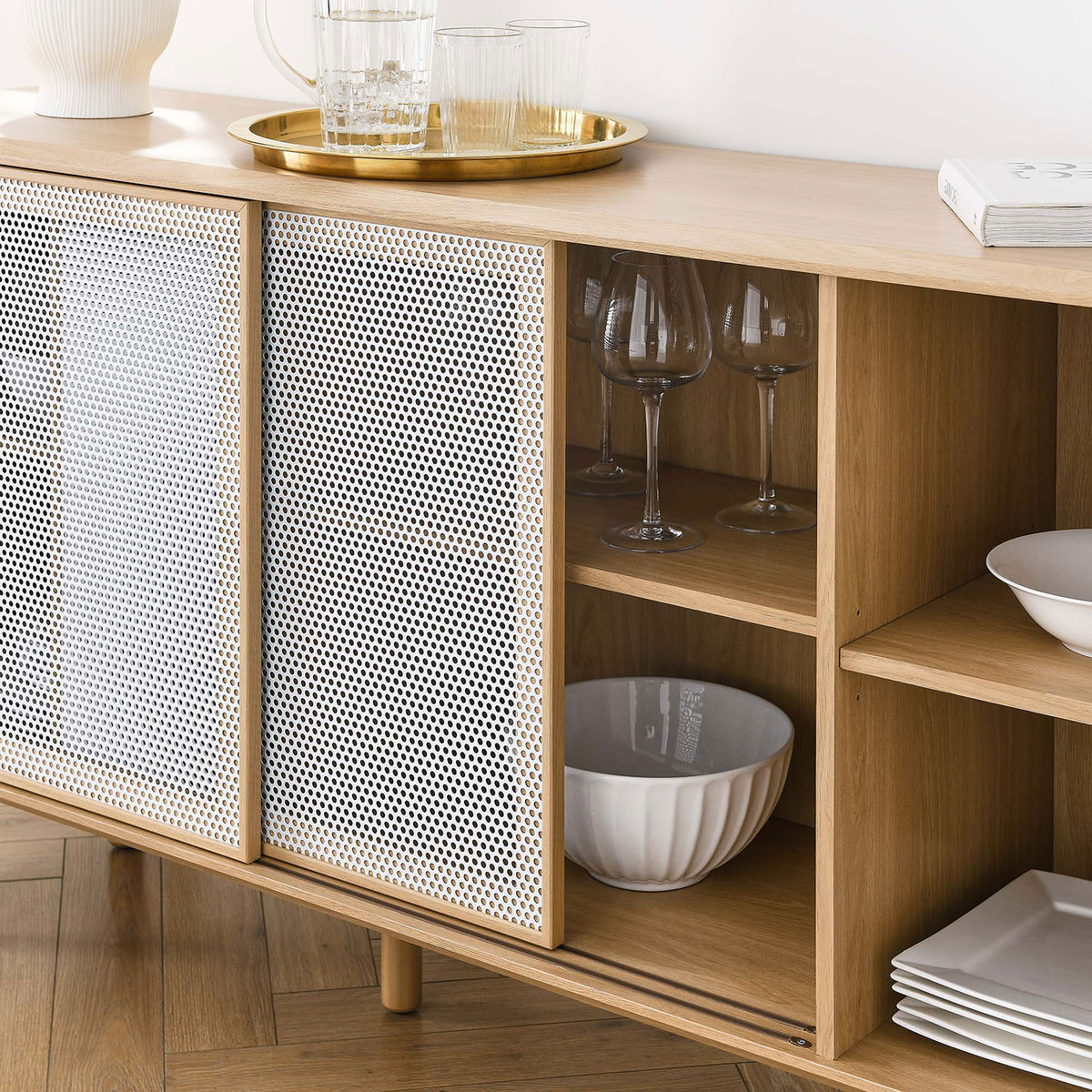 Styled oak sideboard shelves holding glassware and dishes behind the sliding mesh doors. || EEI-6235-OAK || storage_room