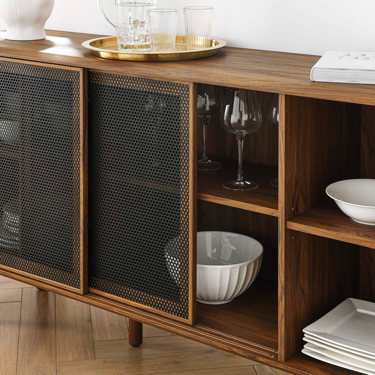 Styled walnut sideboard displaying glassware and dinnerware on open shelves in a bright dining room || EEI-6235-WAL || detail_room