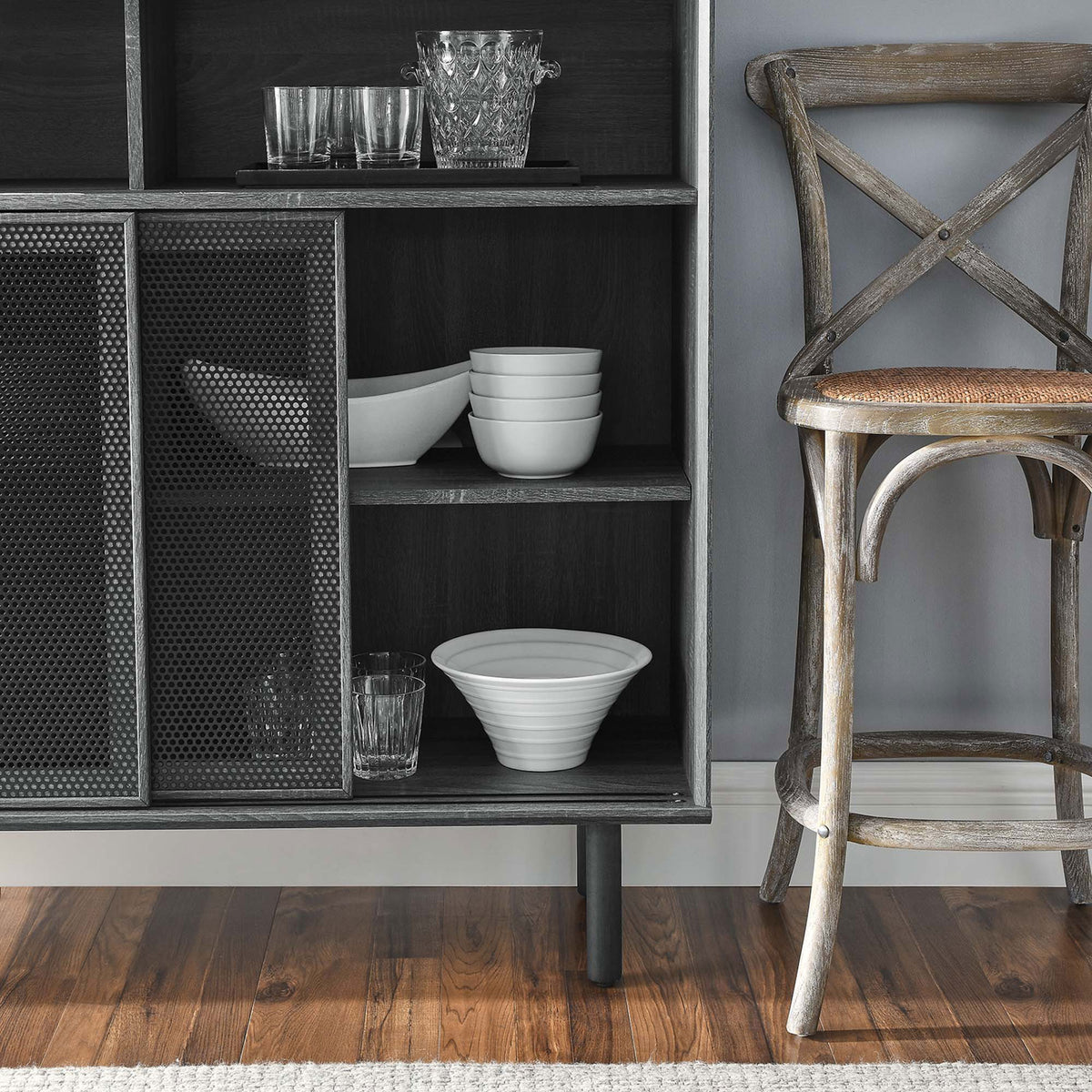 Charcoal cabinet shelves neatly organize dishes and glassware while mesh doors frame the contents with subtle texture. || EEI-6237-CHA || detail_room